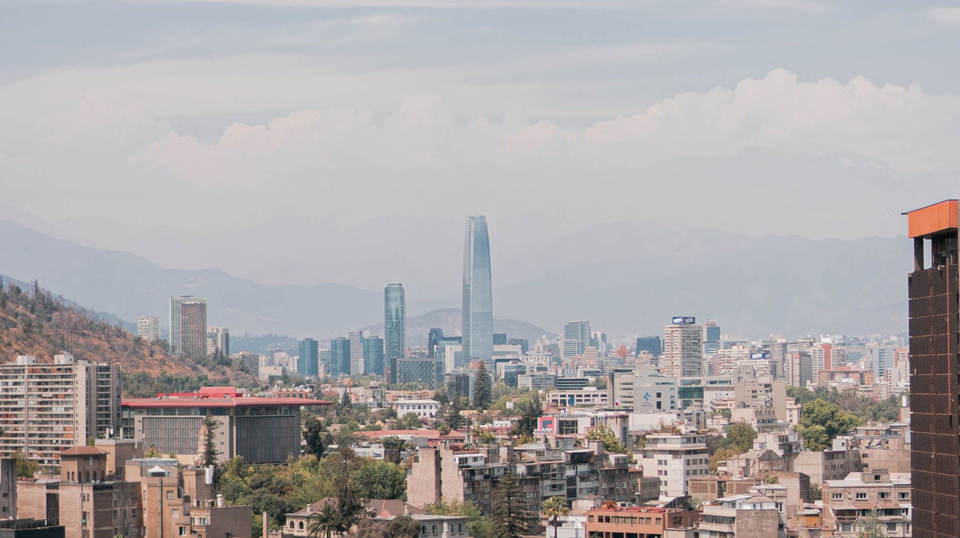 Aerial View of Santiago, Chile Featuring Skyscrapers and Urban Landscape Under a Blue Sky.