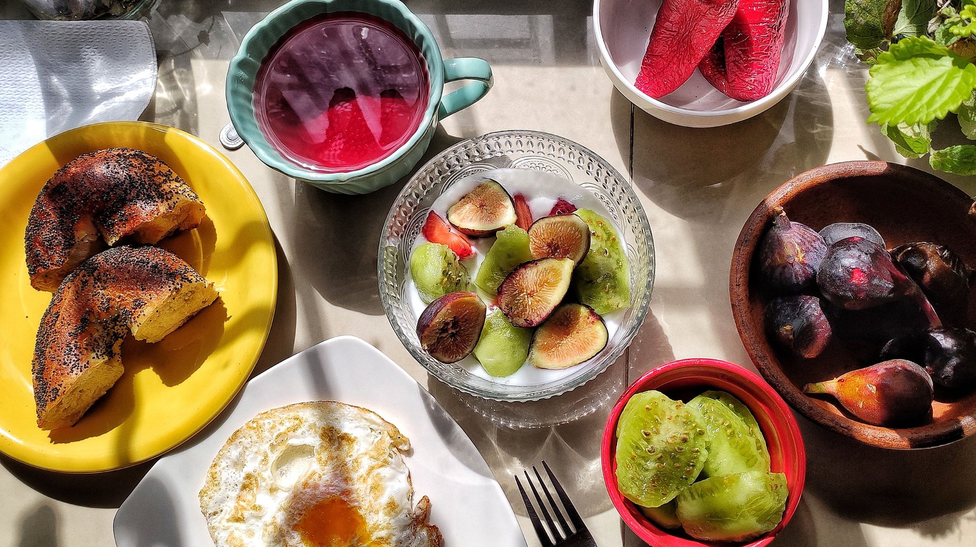 Bright and Healthy Breakfast with Fruits, Bagel, and Egg, Beautifully Arranged.
