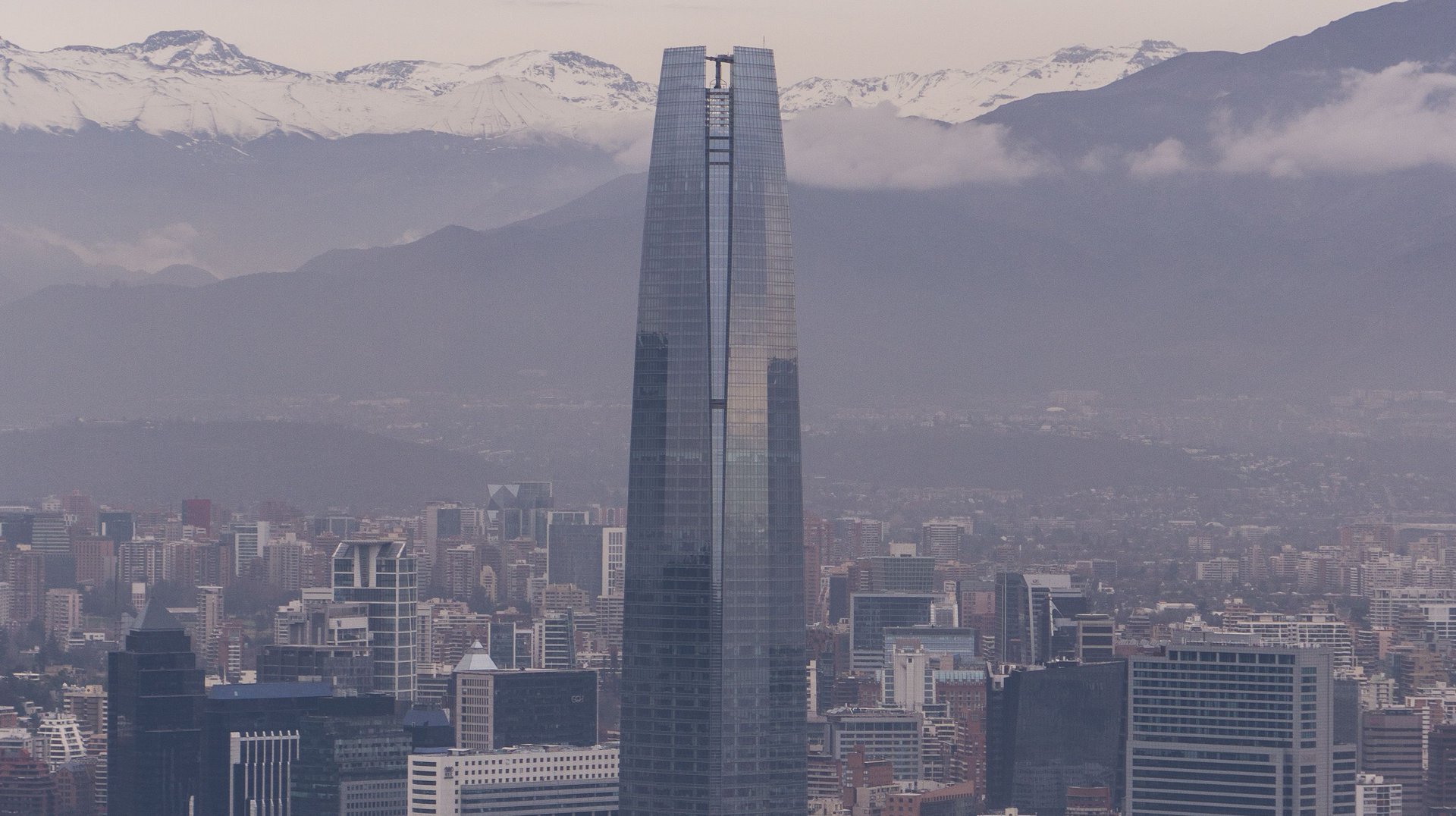 Aerial View of Santiago Cityscape Featuring the Iconic Sky Costanera Tower Under a Foggy Sky.