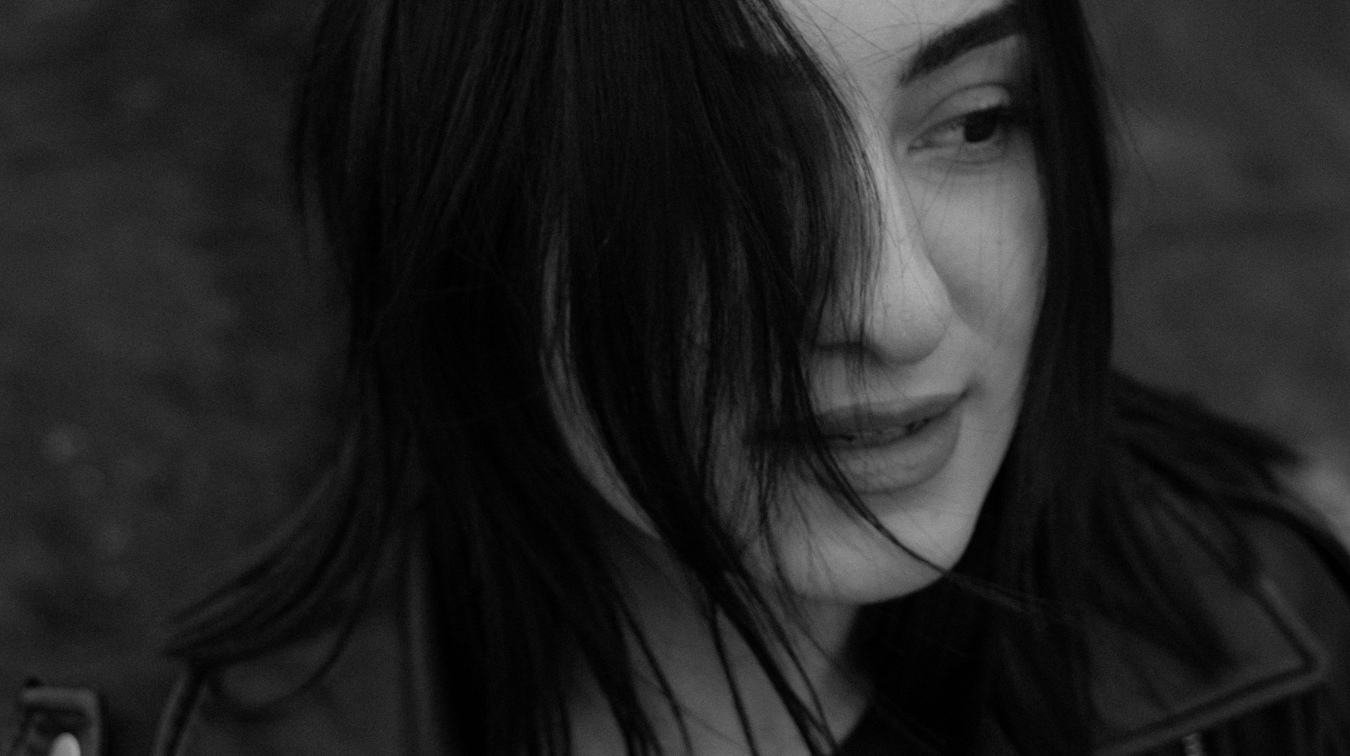 Artistic Black and White Portrait of a Woman Wearing a Leather Jacket Outdoors.