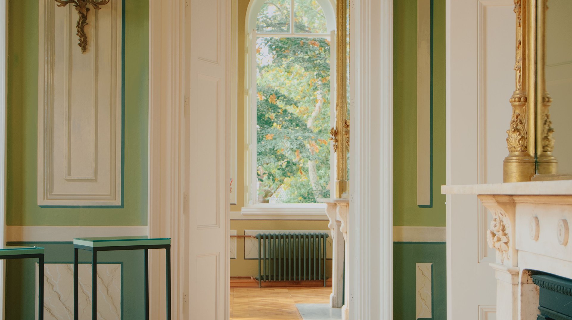 a Peaceful Room with Classic Architectural Details and a Sunlit View of a Lush Garden.