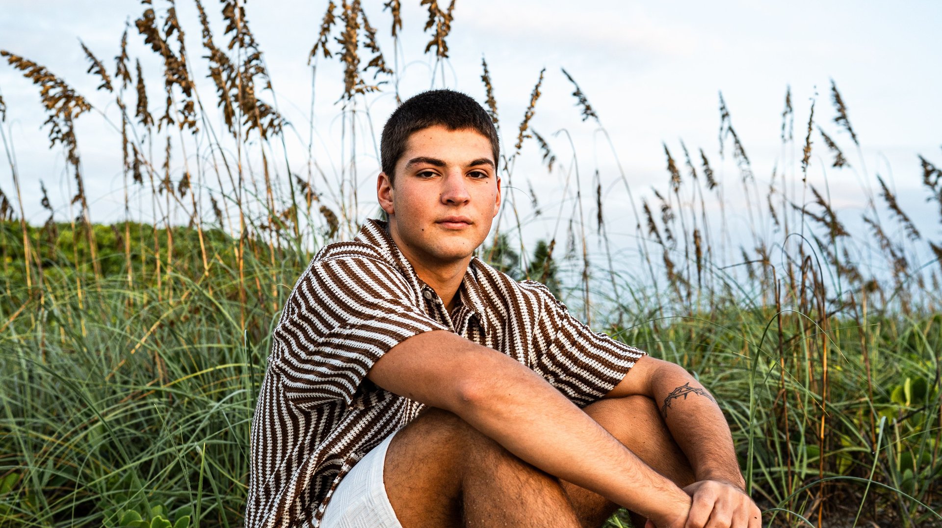 Young Man Relaxing on the Sand at Melbourne Beach, Florida During Sunset.