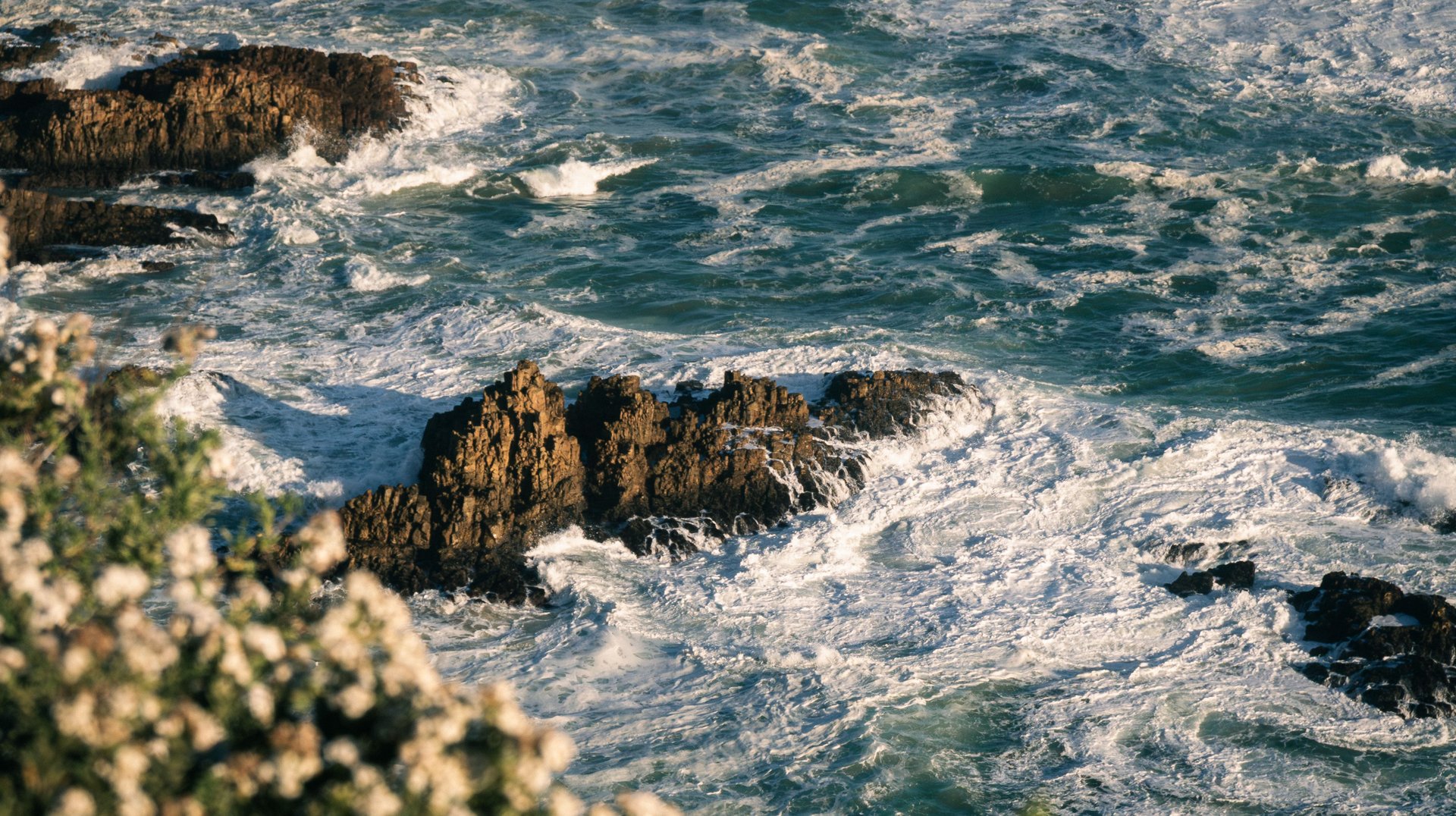 Majestic Ocean Waves Crashing Against Rocky Shoreline in South Africa, Capturing Nature's Raw Power.