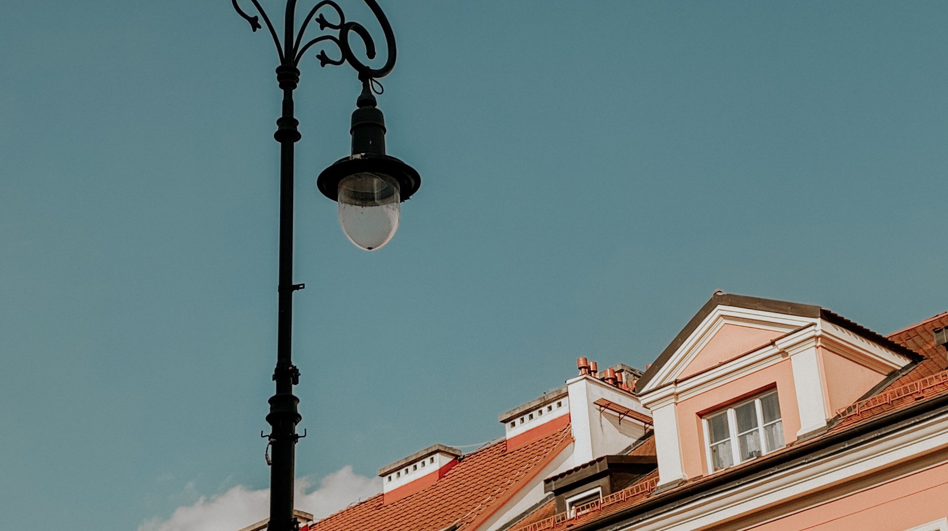 Elegant Buildings with a Streetlamp in Warsaw, Poland. Classic European Architecture Under a Clear Blue Sky.