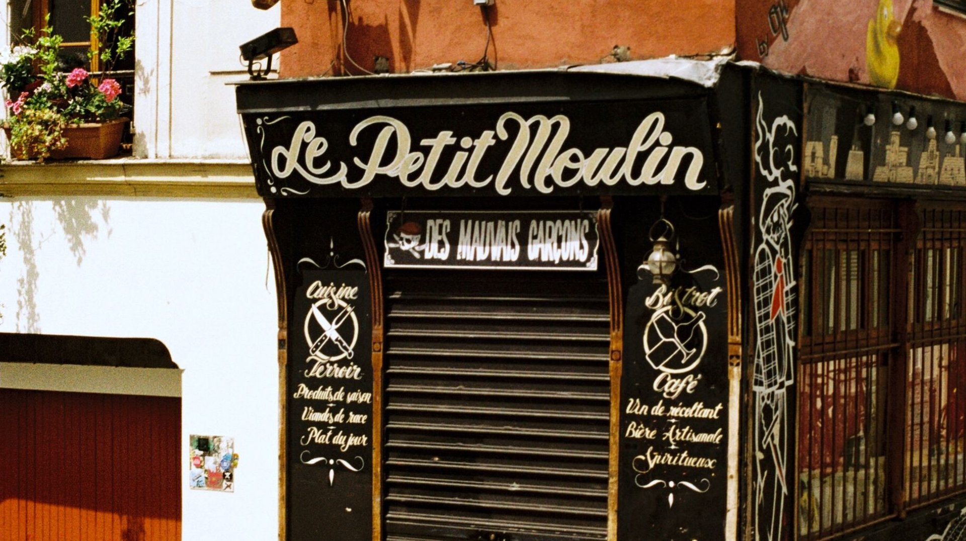 Discover the Quaint Charm of Le Petit Moulin on Rue Tholozé in Paris, France.