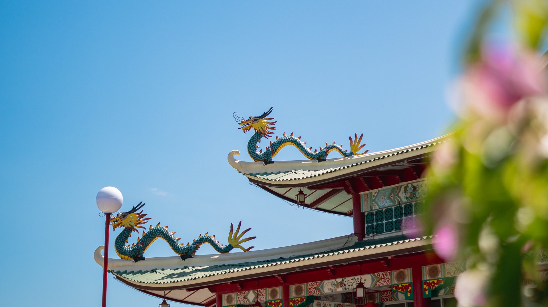 Traditional Temple with Dragon Sculptures Under a Clear Blue Sky in Central Visayas.