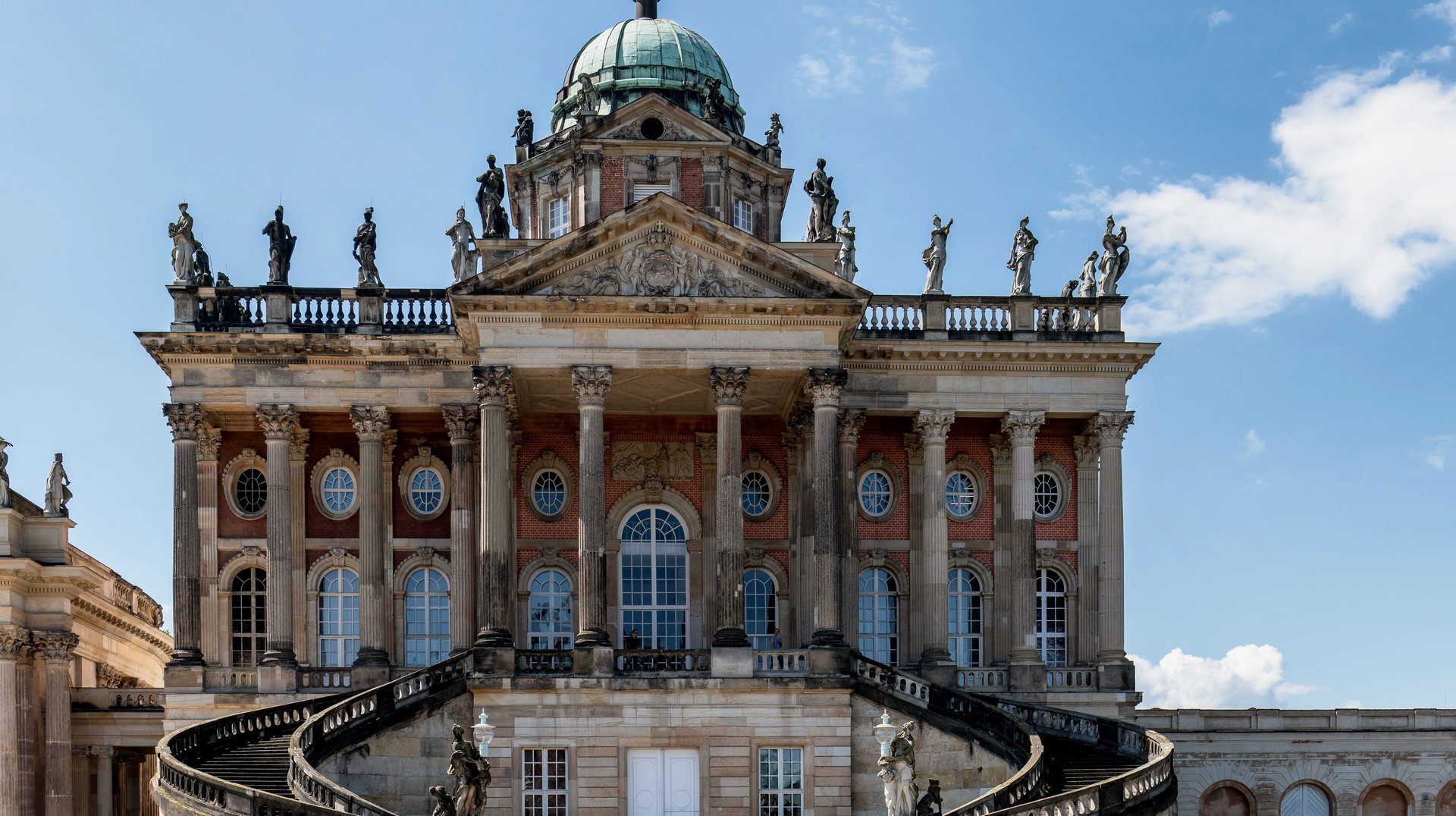 Captivating Front View of Sanssouci Palace Showcasing Its Stunning Baroque Architecture Under a Bright Sky.