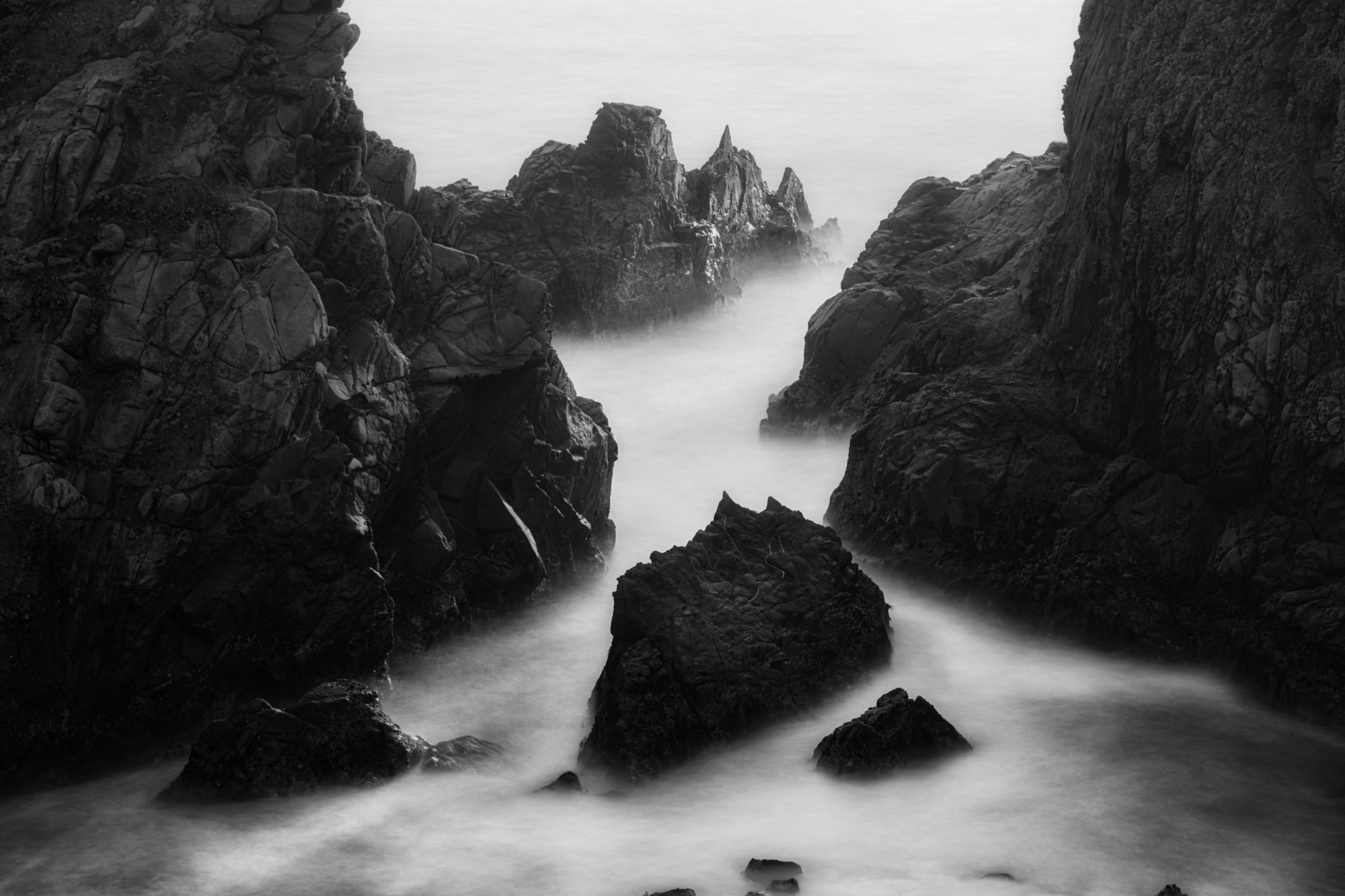 Rocky Coastline With Misty Ocean Waves