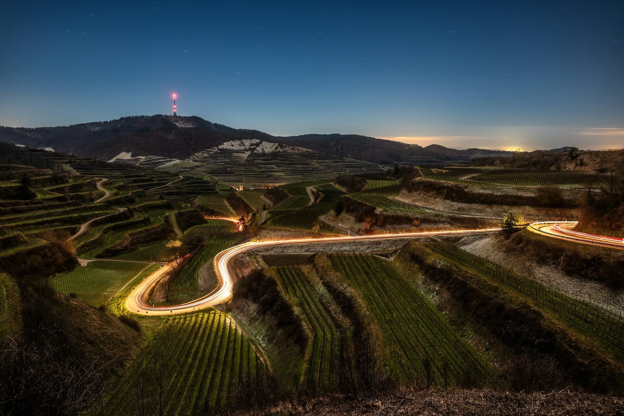 Winding Road Through Terraced Hills At Dusk