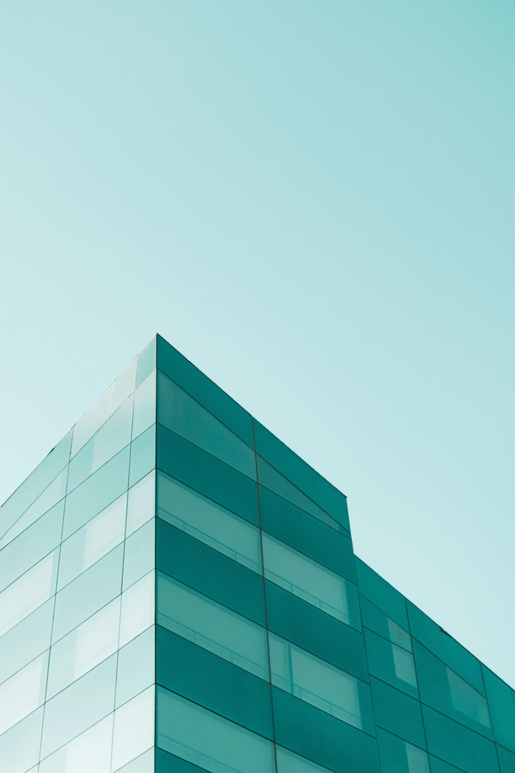 Modern glass building against a clear sky