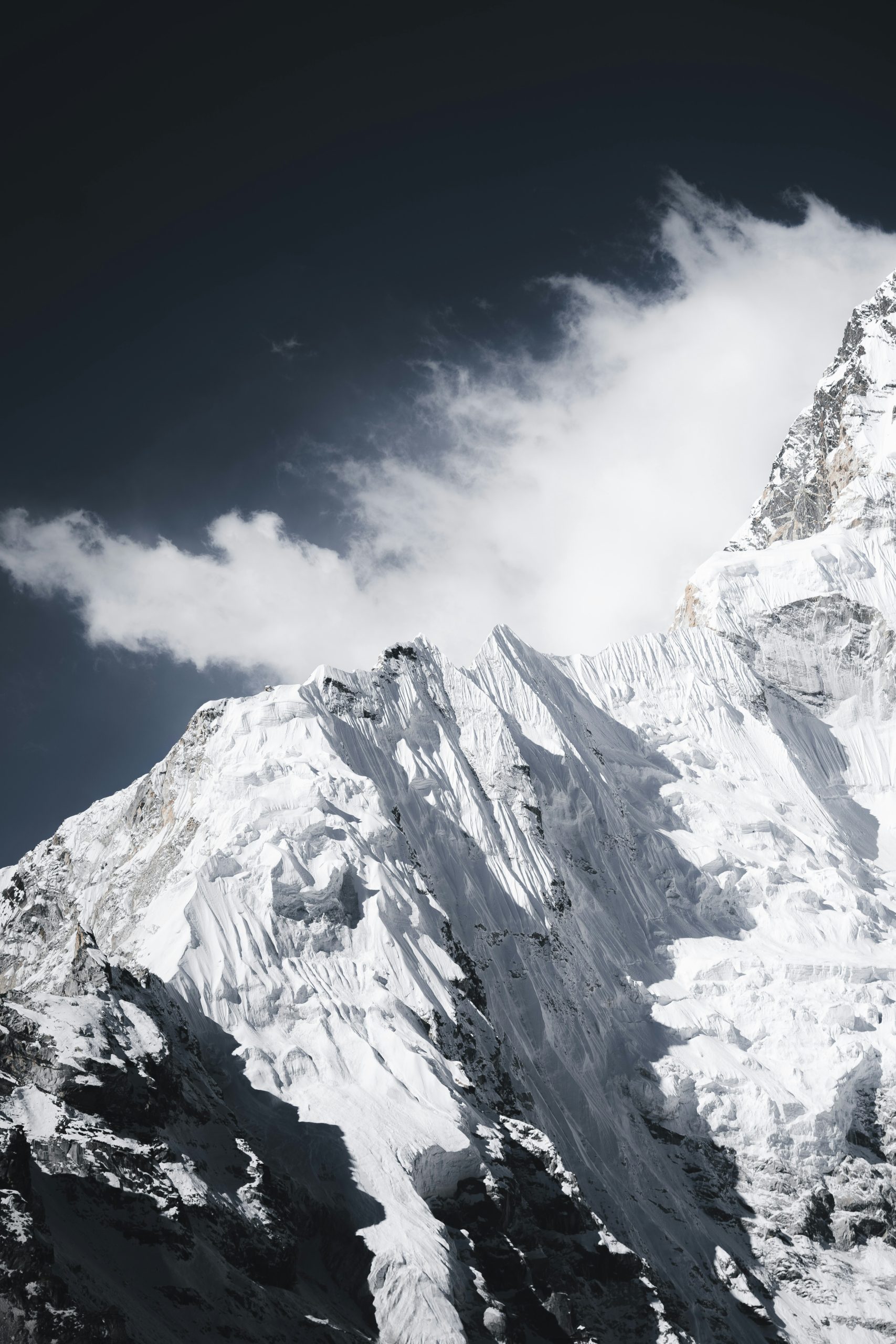 Snow-covered mountain peak against a dark sky