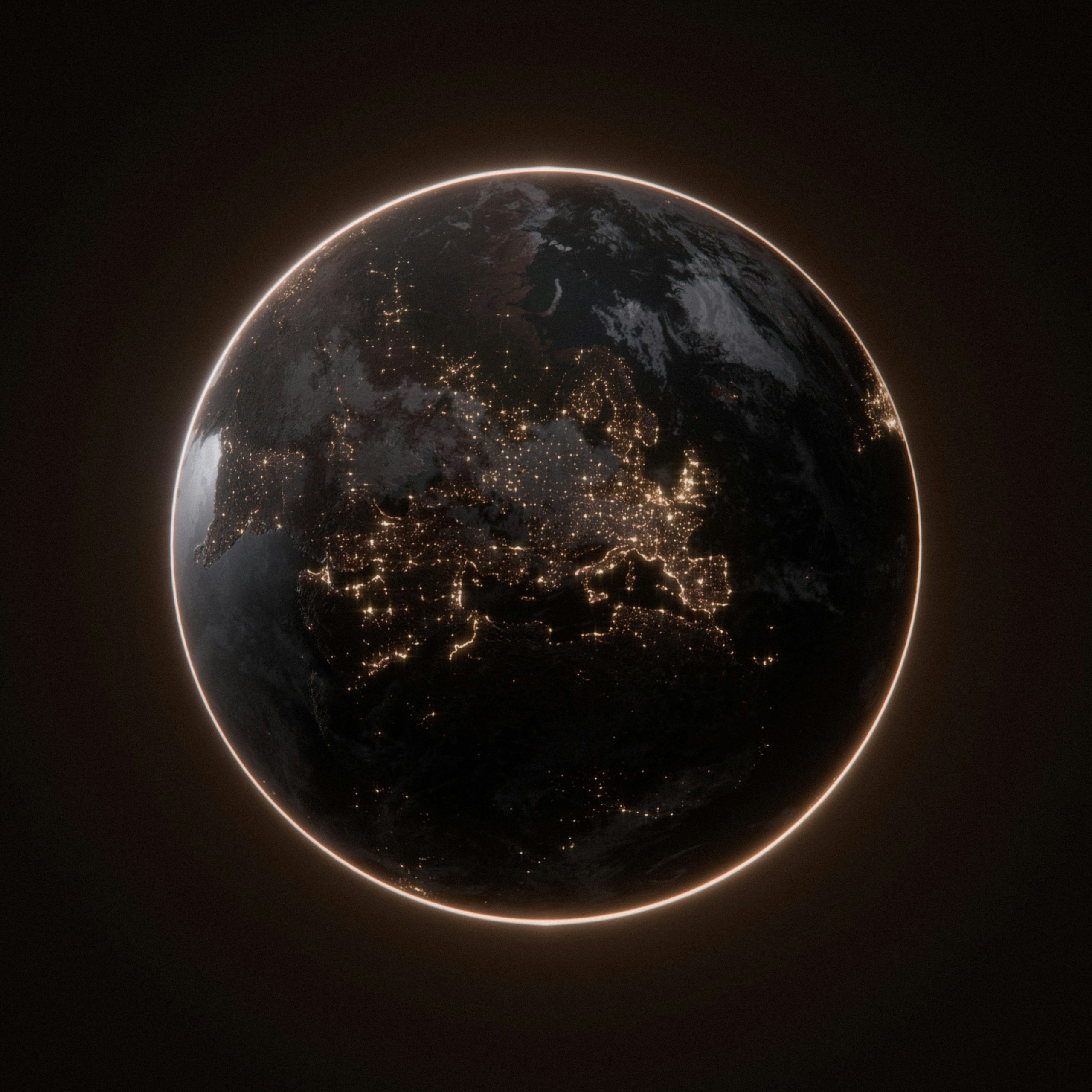 Earth at night with glowing city lights visible