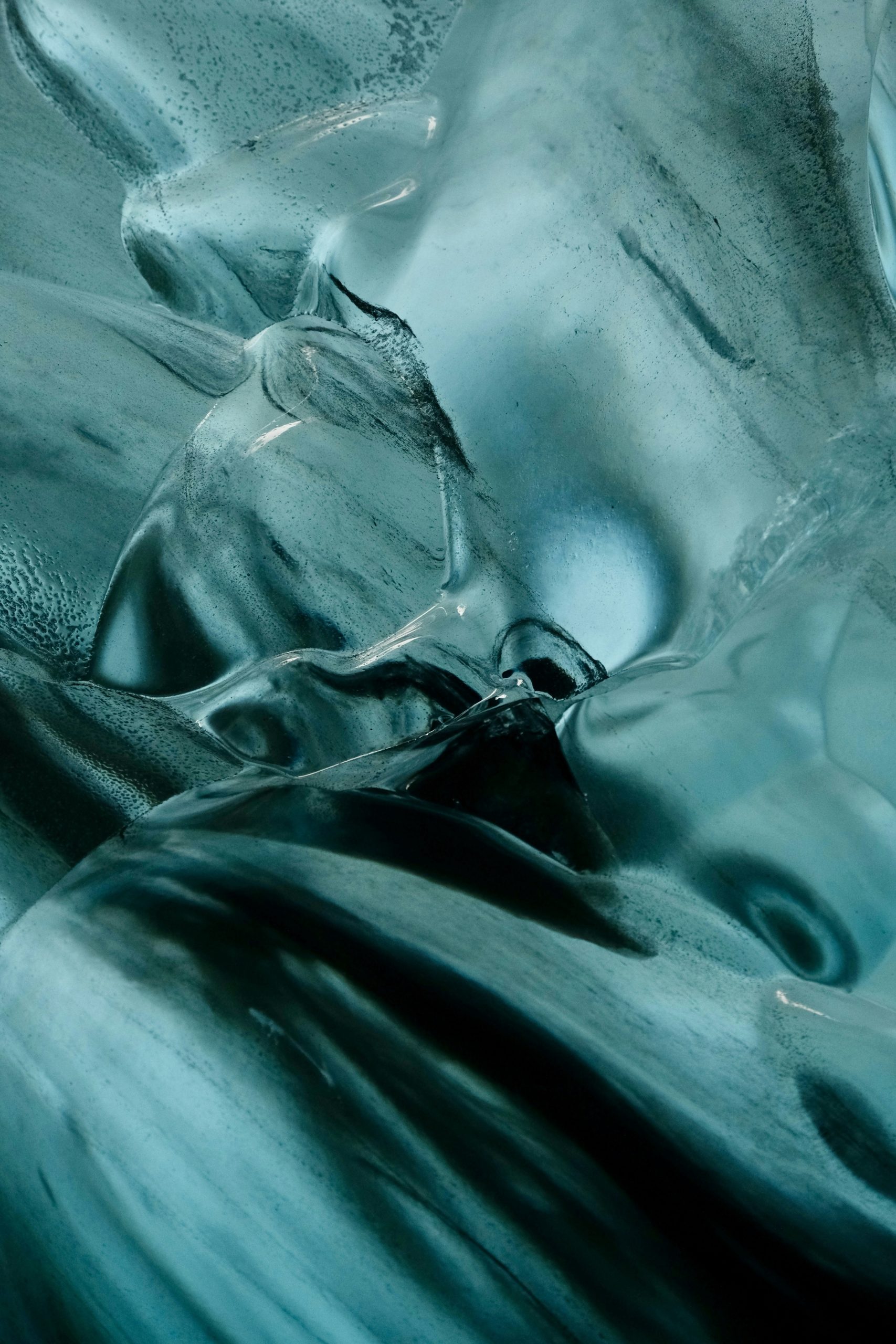 Abstract patterns of blue ice inside a glacial cave