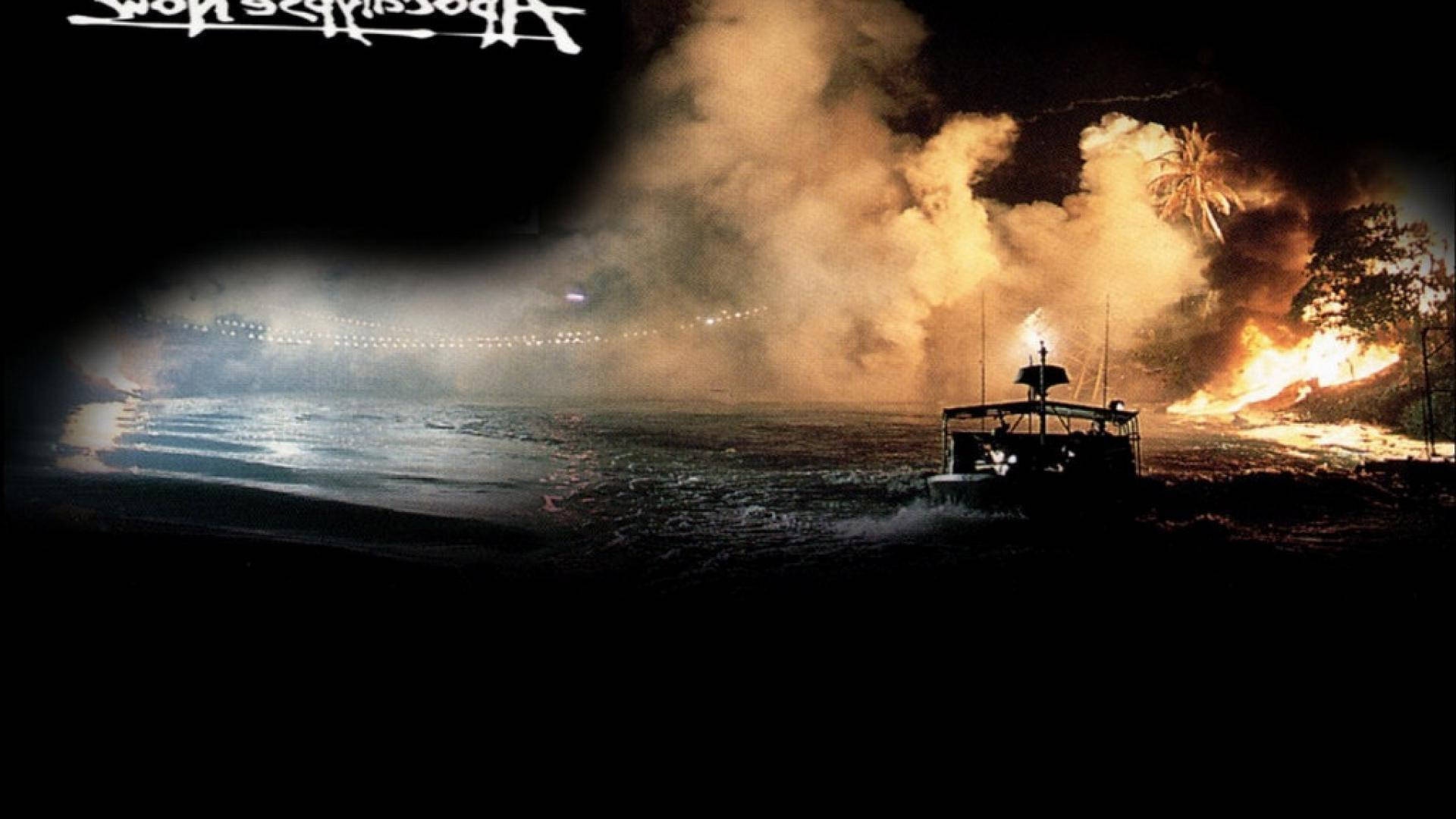 Boat navigating dark waters with jungle fire and smoke behind it at night.