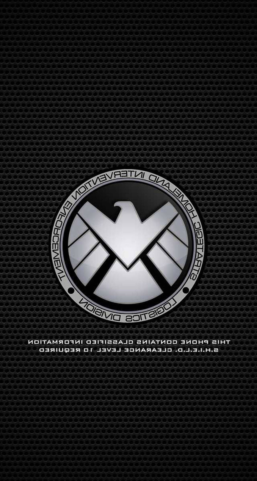 S.H.I.E.L.D. Logistics Division emblem on black perforated metal with clearance warning text. – Ultra HD Wallpaper