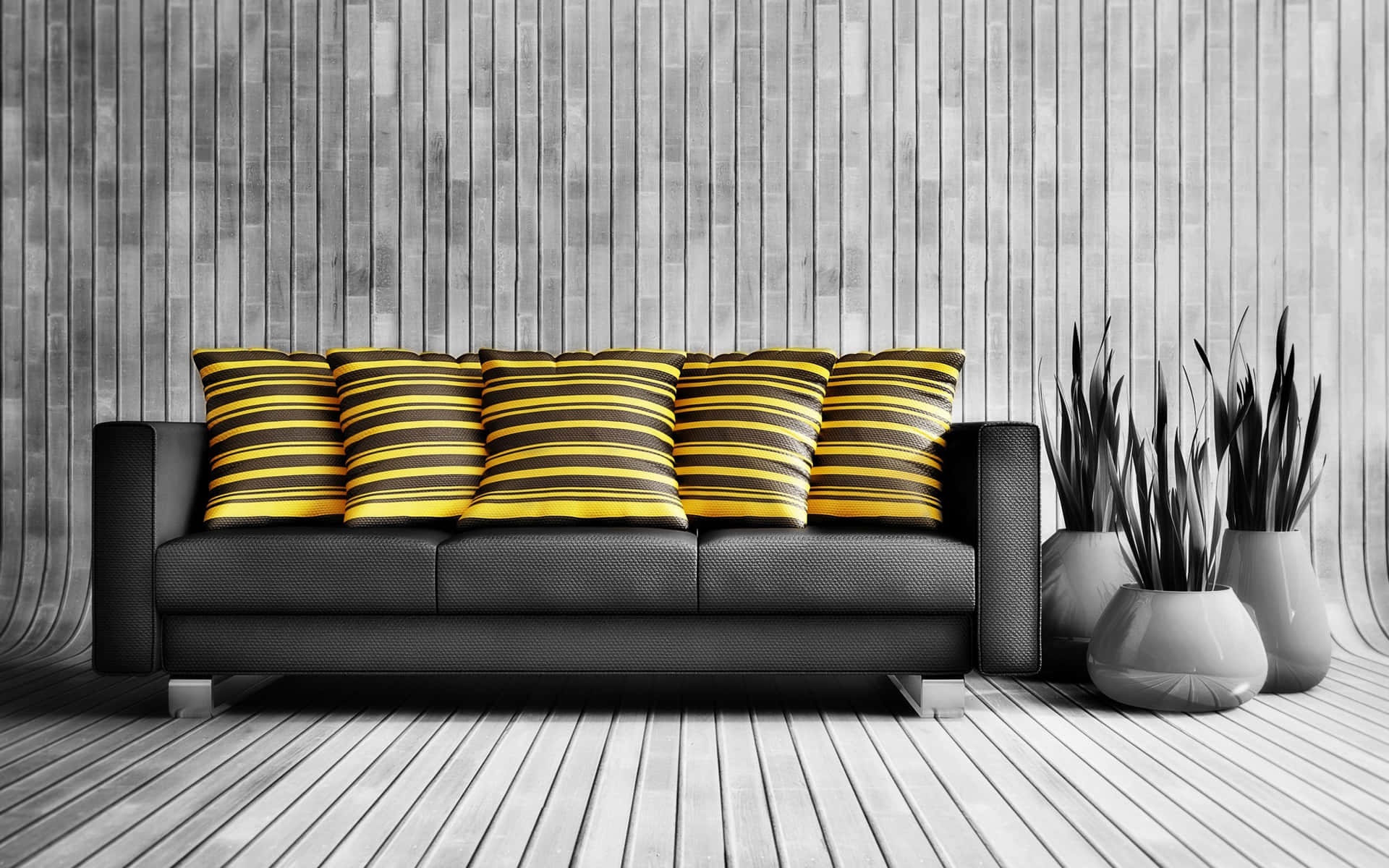 Black sofa with yellow striped pillows in a modern gray wood room.
