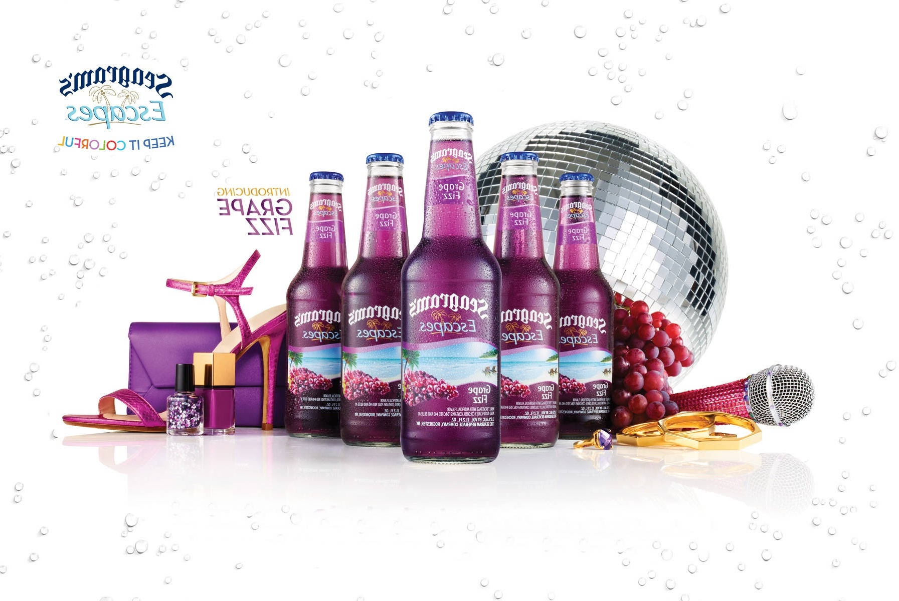 Purple soda bottles with disco ball microphone grapes and high heels on white background.