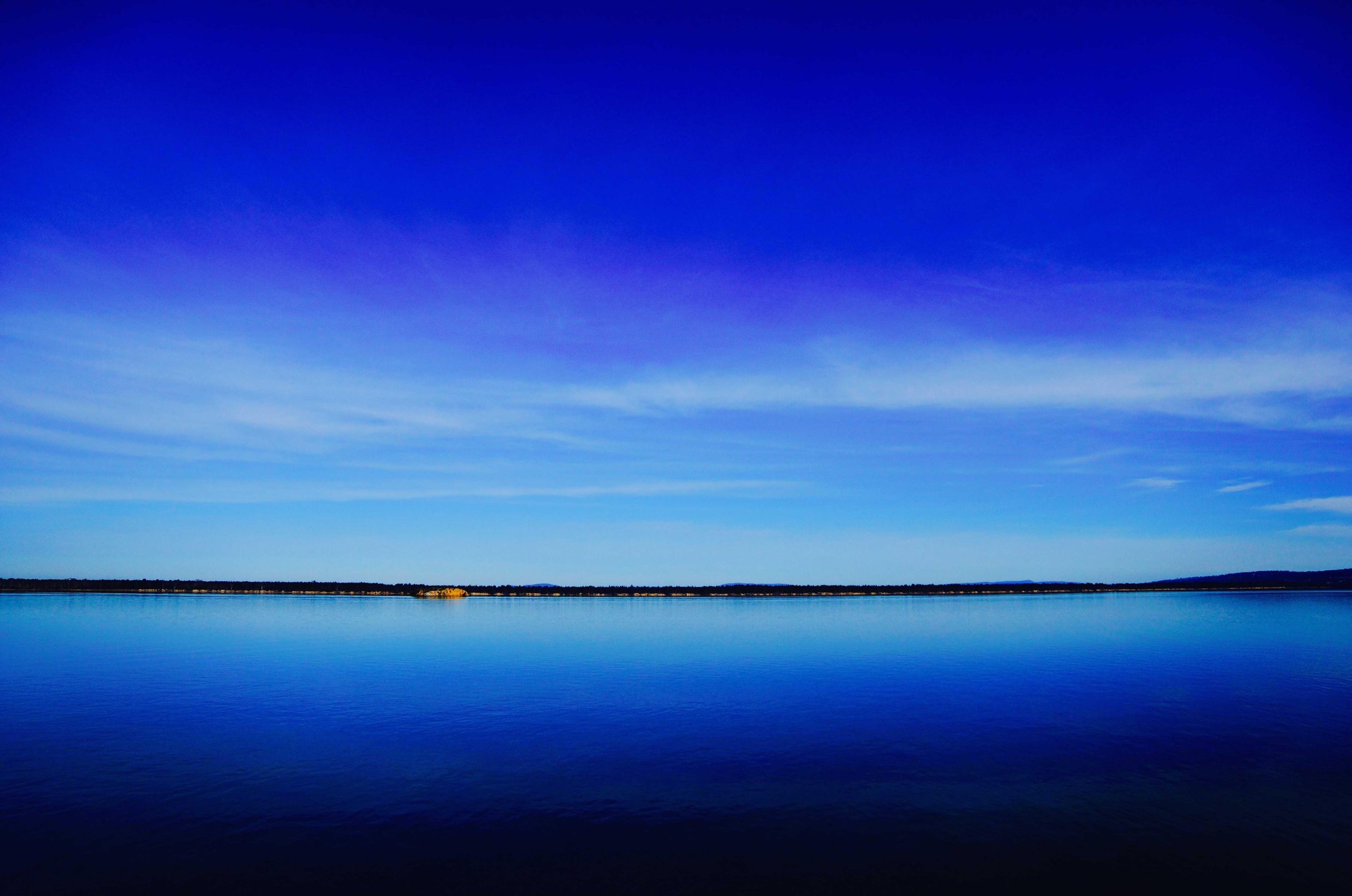 Cool blue tones of a winter morning frost on a quiet lake