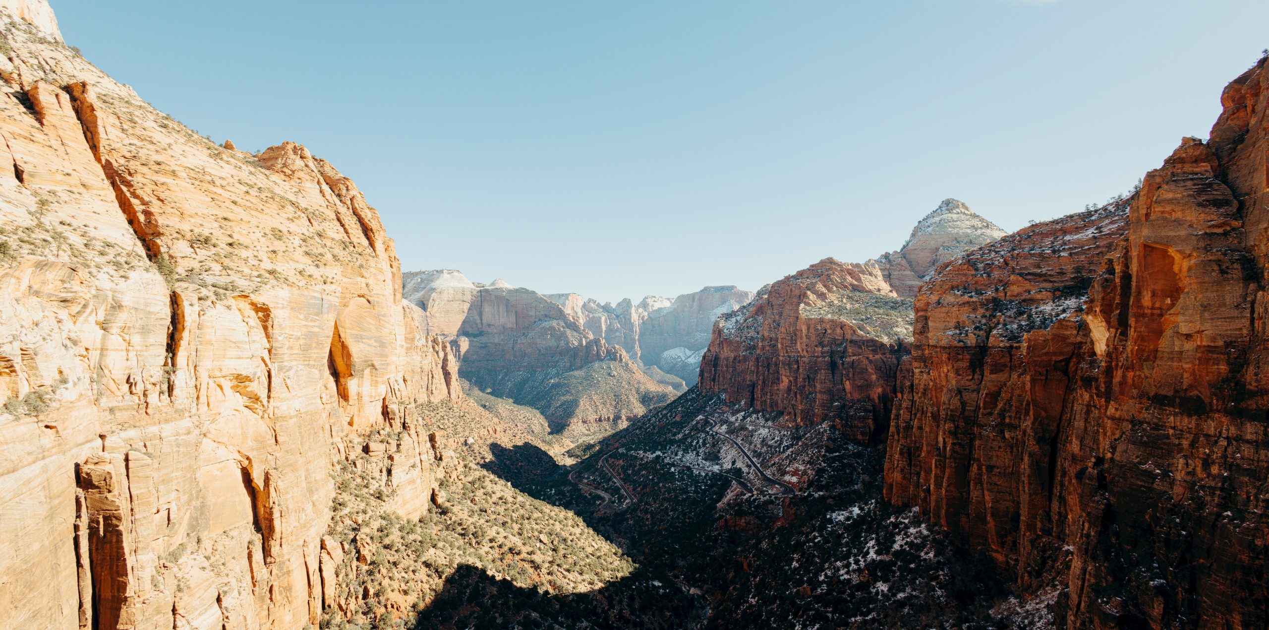 Rugged sandstone cliffs under a clear blue sky.