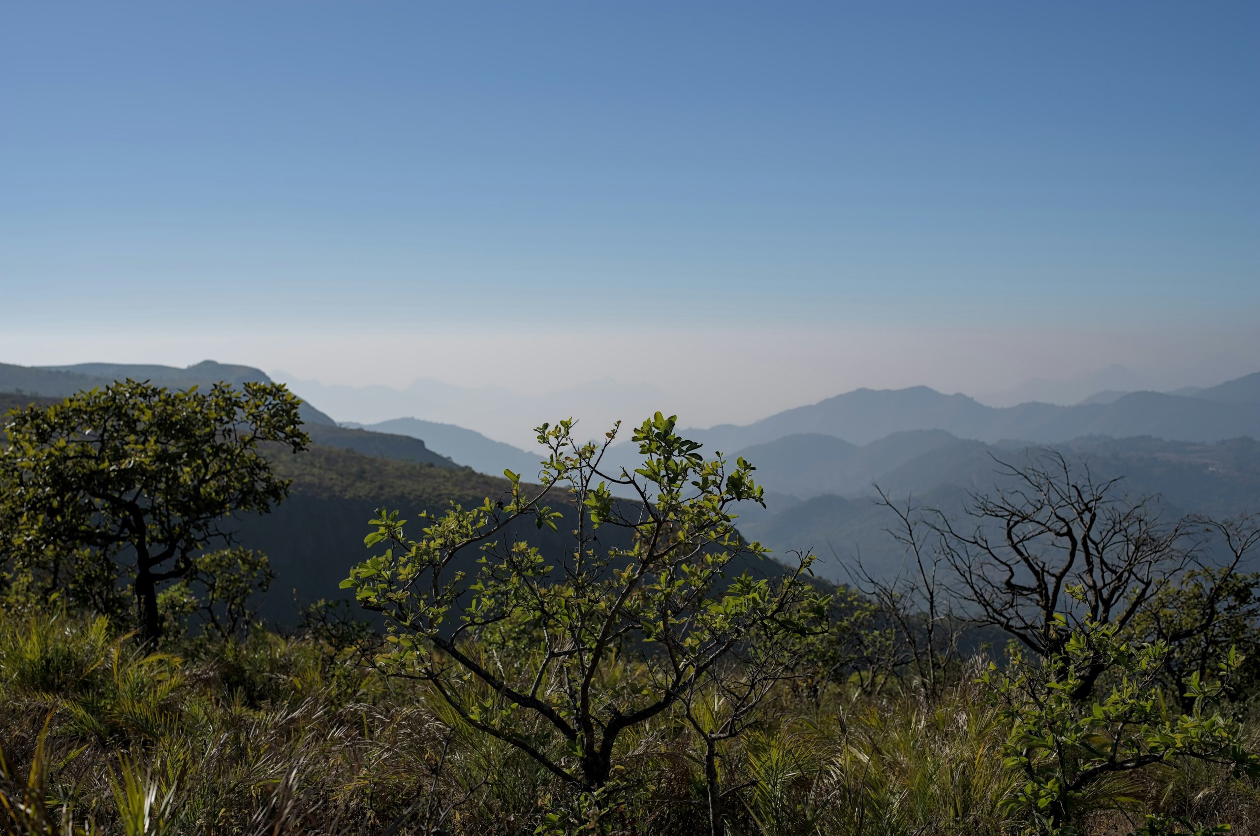 Layered mountain ranges under a clear blue sky.