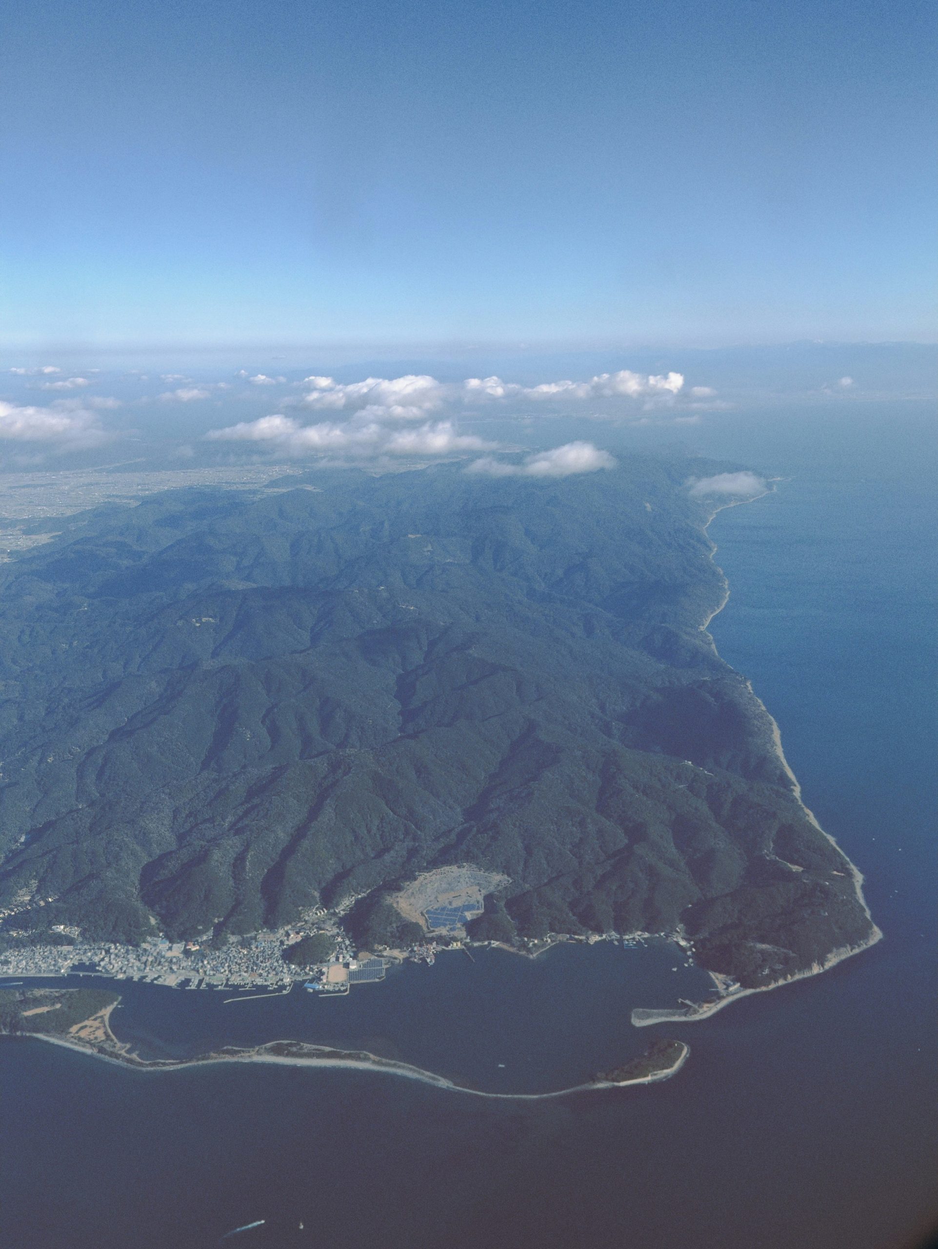 Aerial view of a coastal mountain range with a town.