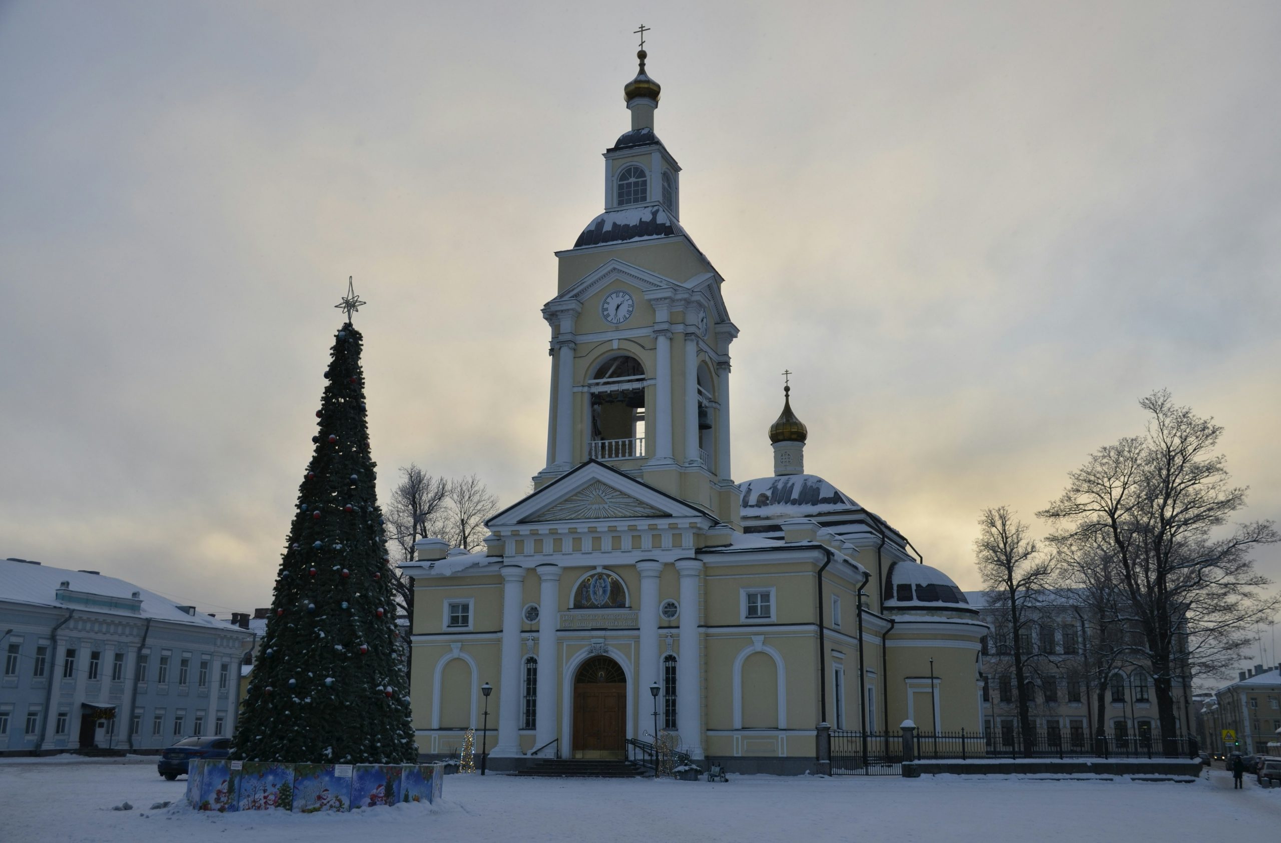 Church with christmas tree in snowy town square