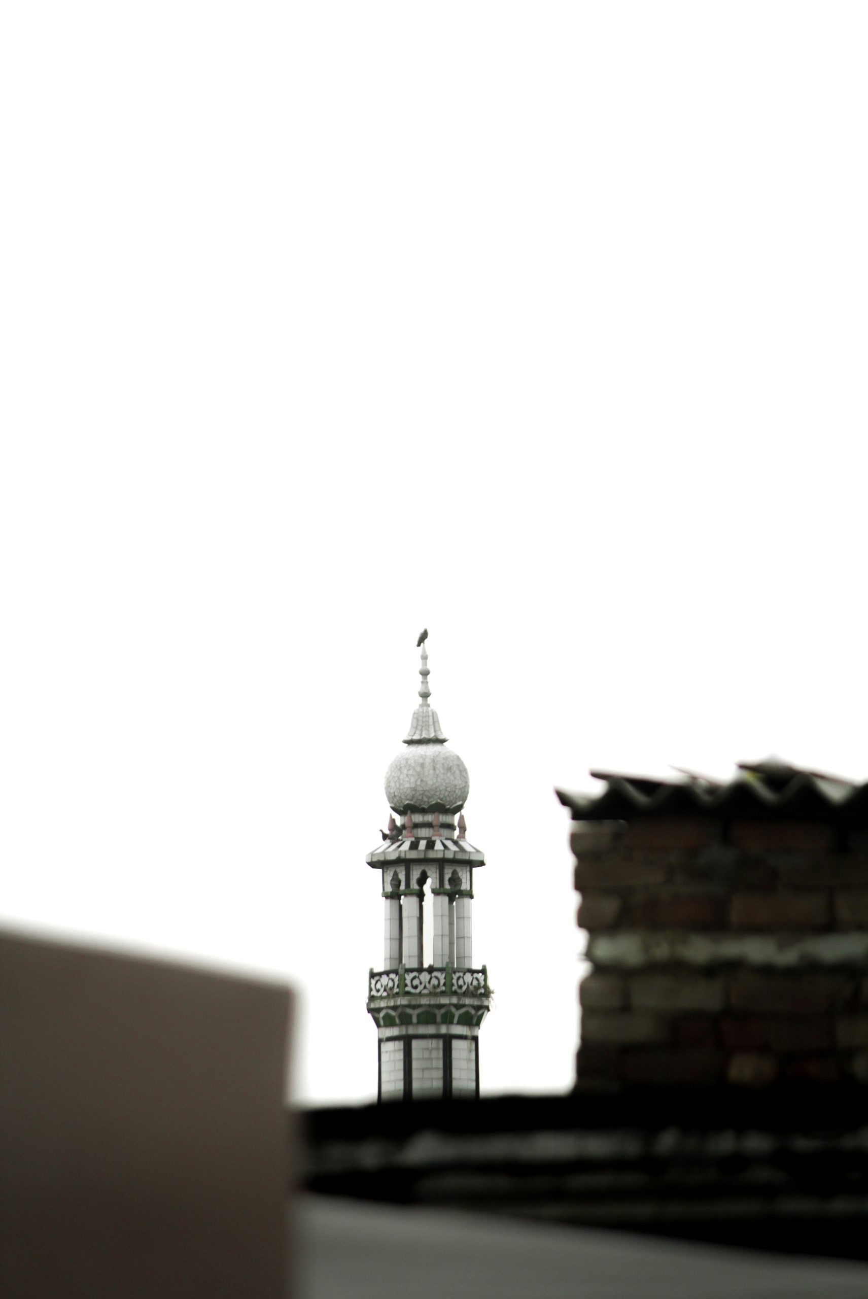 Minaret of a mosque against a bright sky