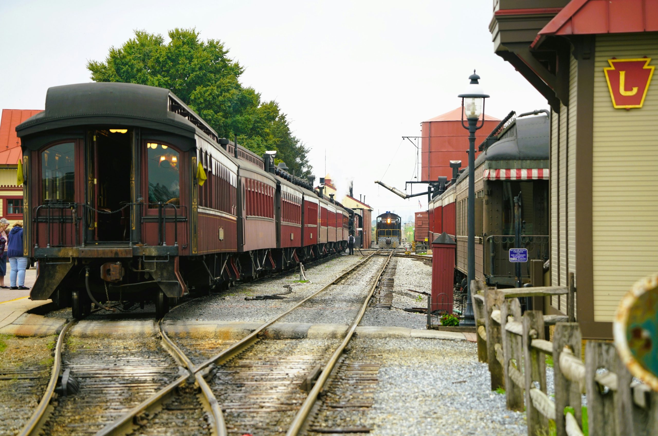 Vintage trains at a station on a cloudy day