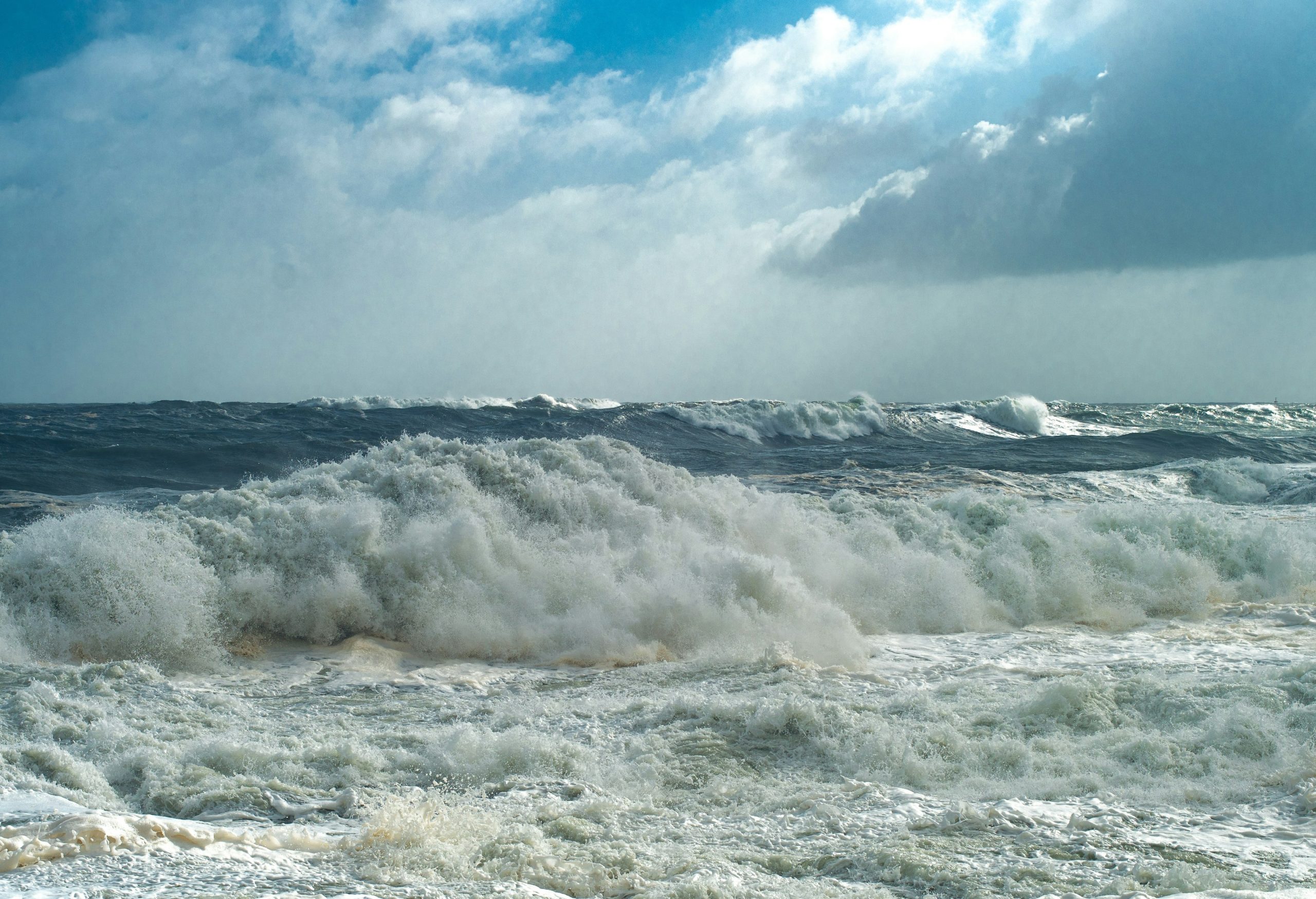 Crashing ocean waves under a stormy sky