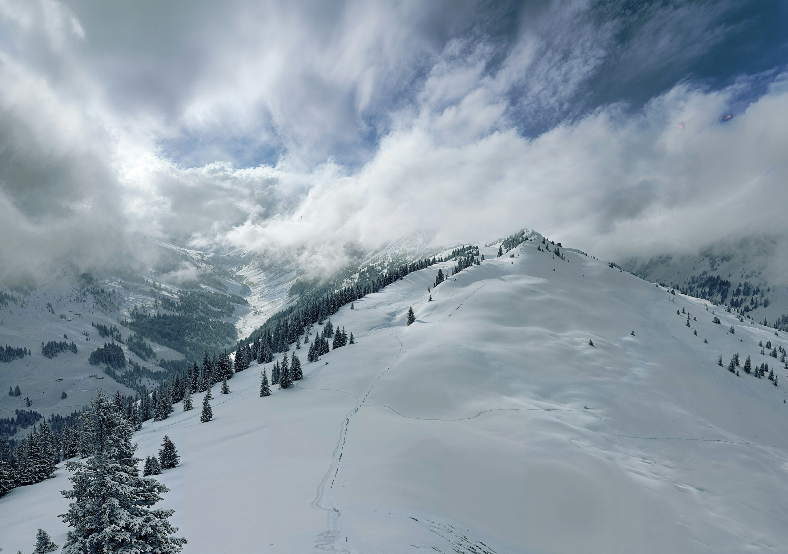 Snowy mountain ridge with dramatic clouds