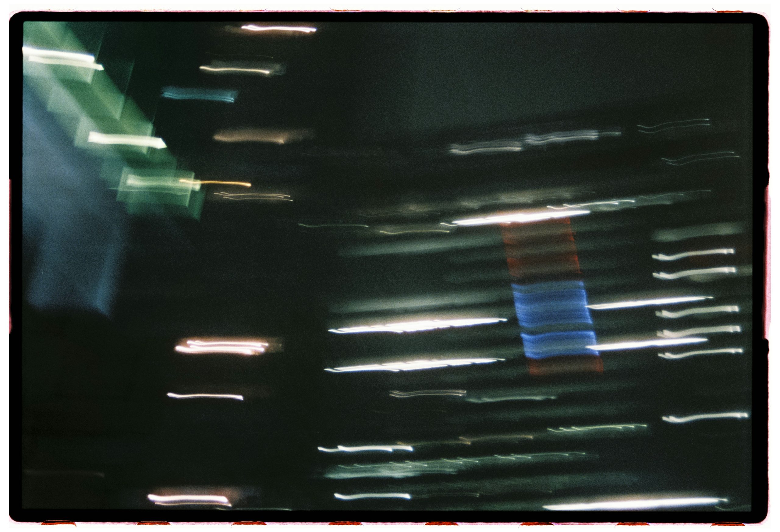 Streaks of light blur across dark background