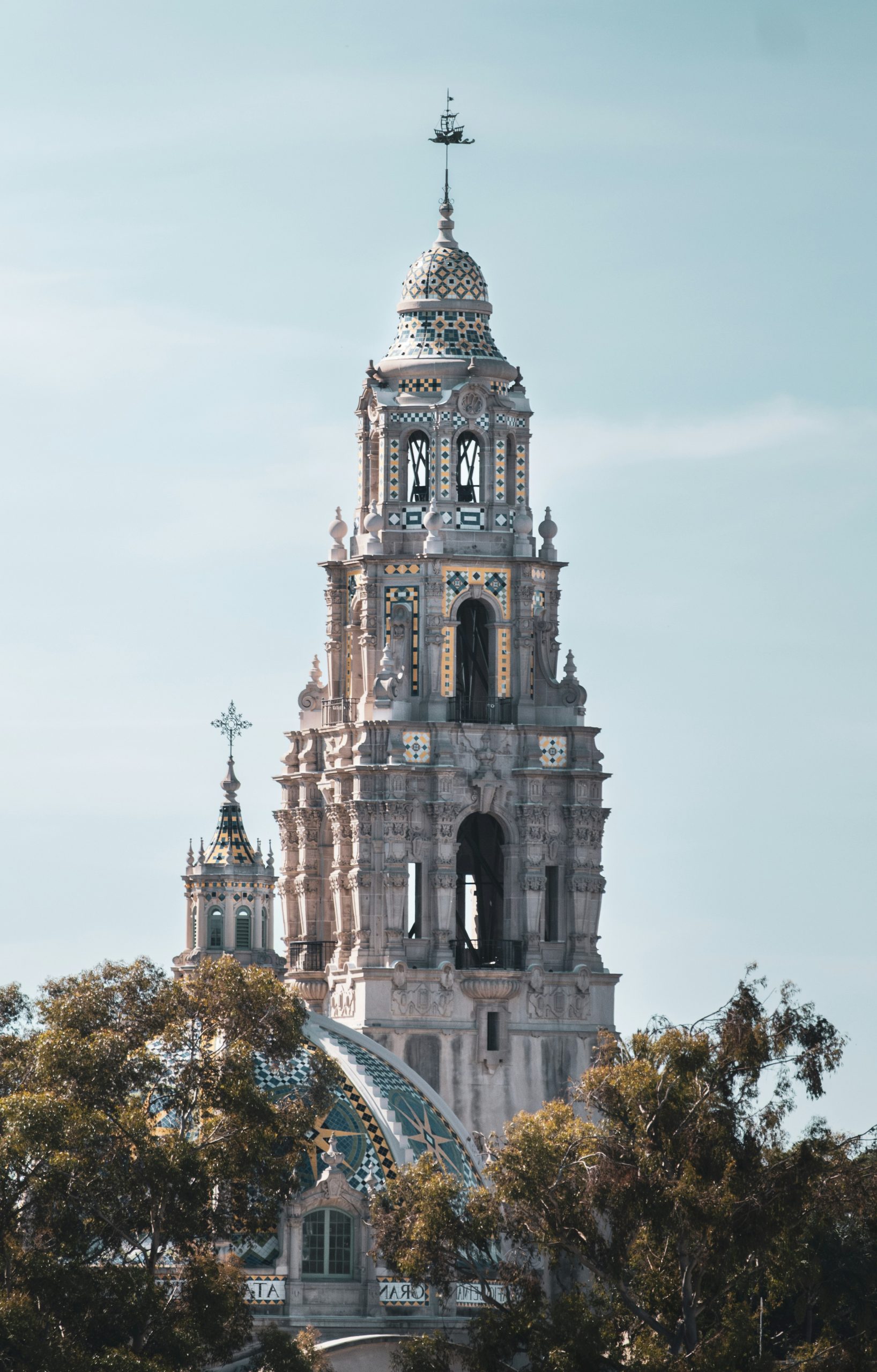 Ornate historic tower with trees in foreground
