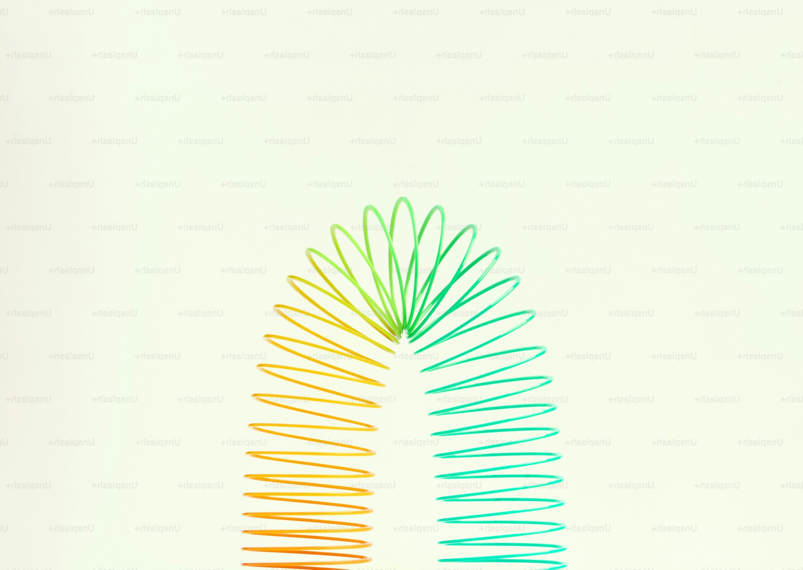 A colorful slinky toy against a white background