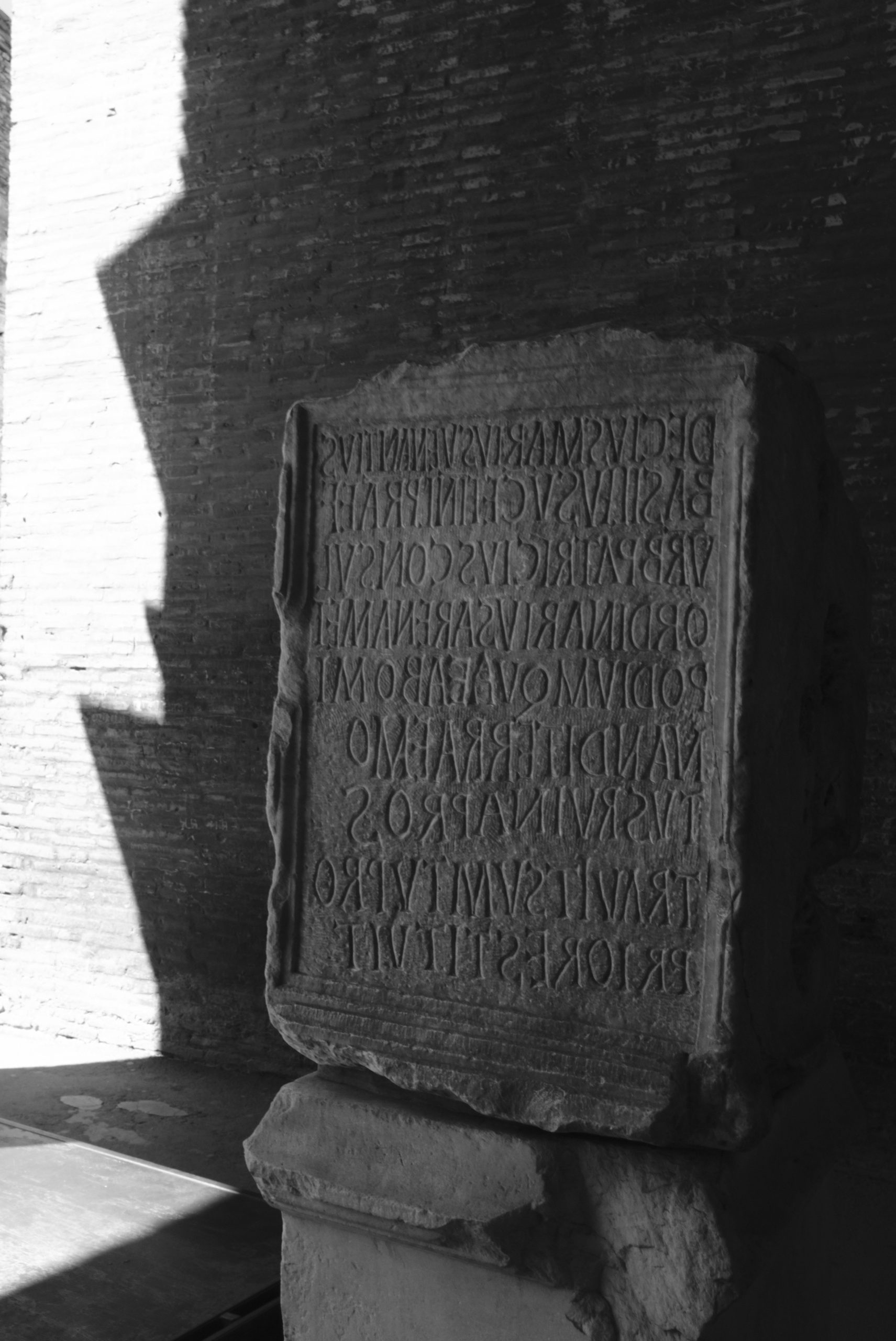 Ancient stone tablet with carved latin inscription.