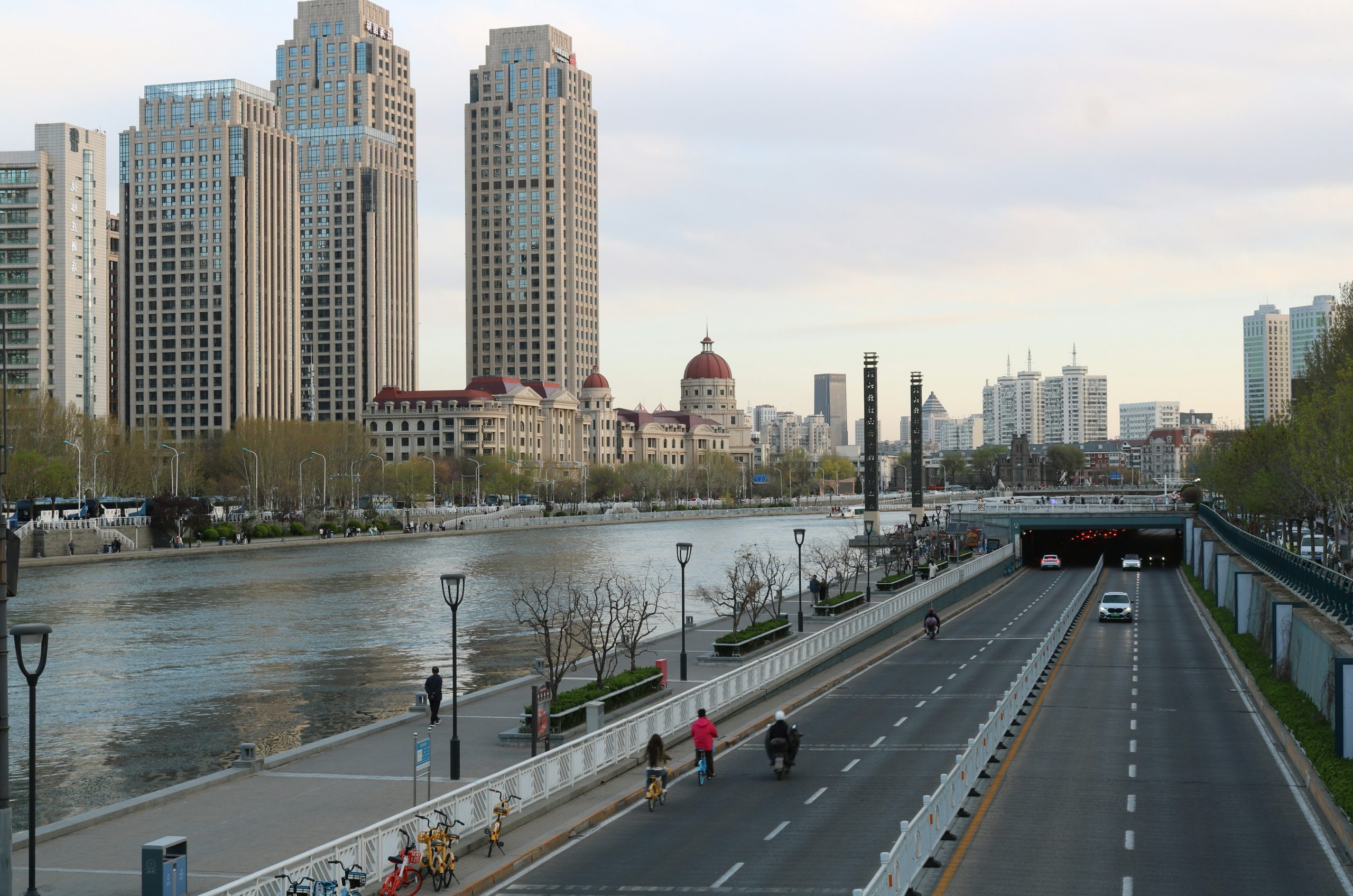 Cityscape with river, road, and modern buildings