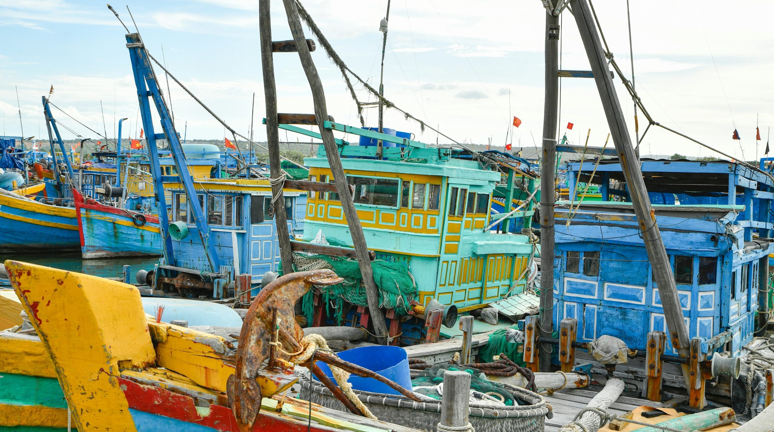 Colorful fishing boats docked in a harbor.