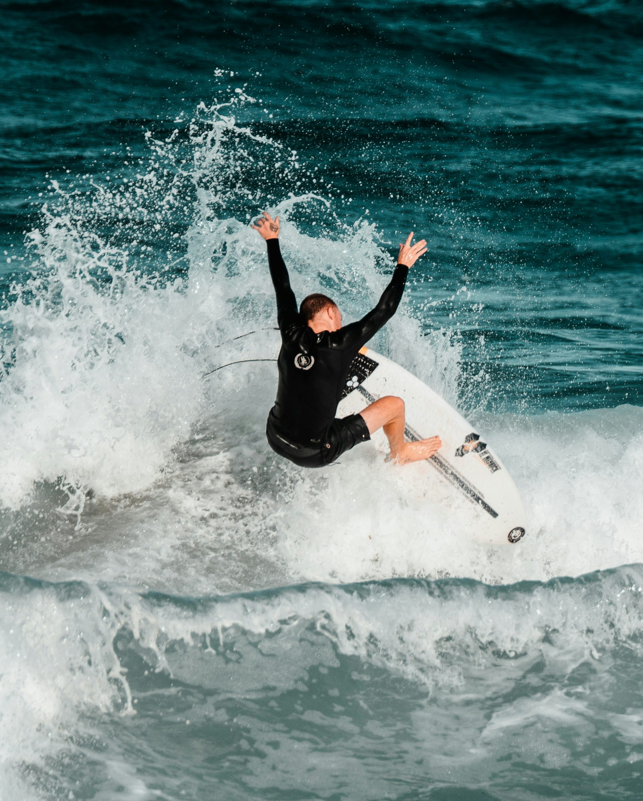 Surfer catches a wave, spraying water