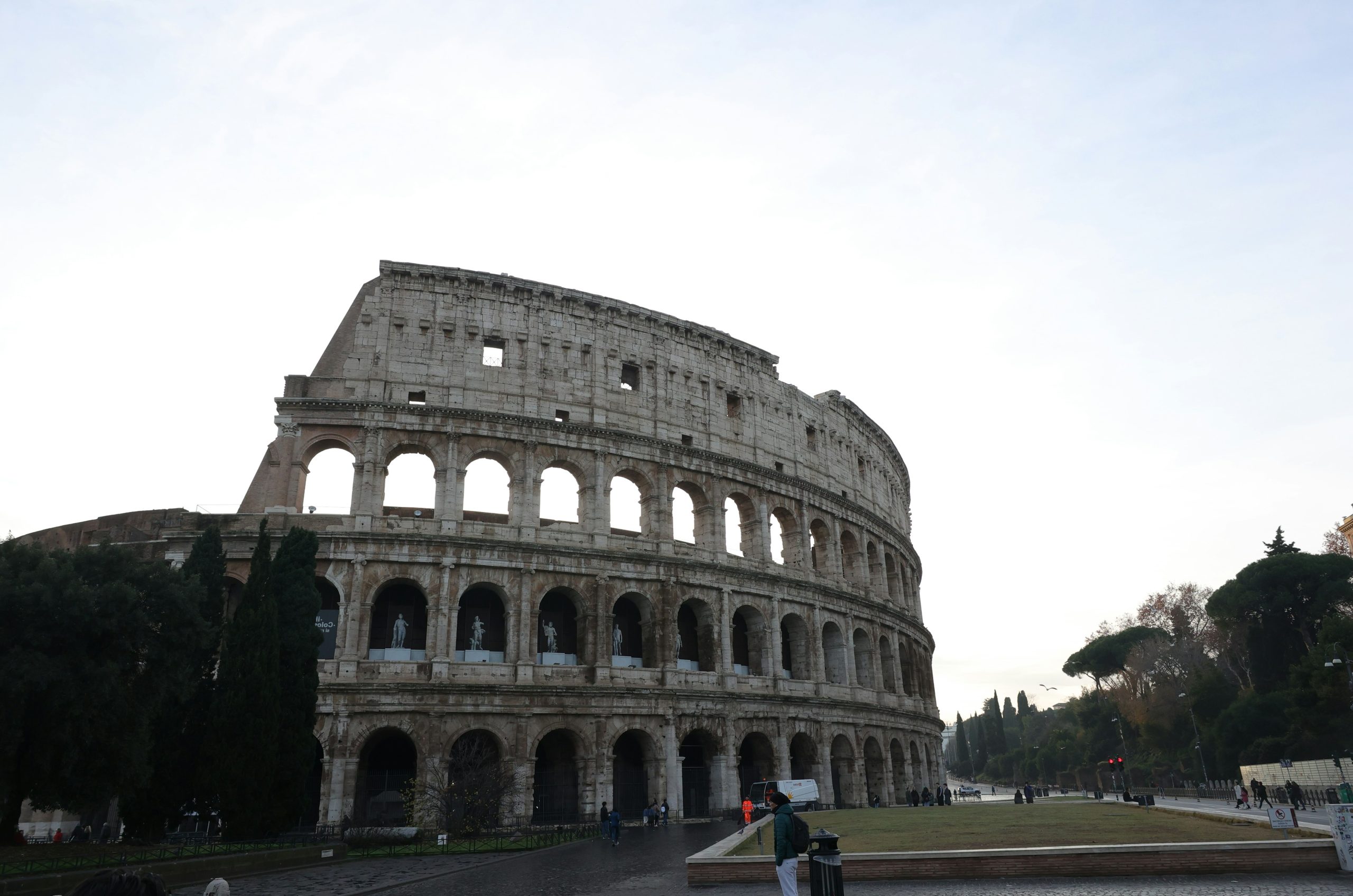 The colosseum in rome under a bright sky.