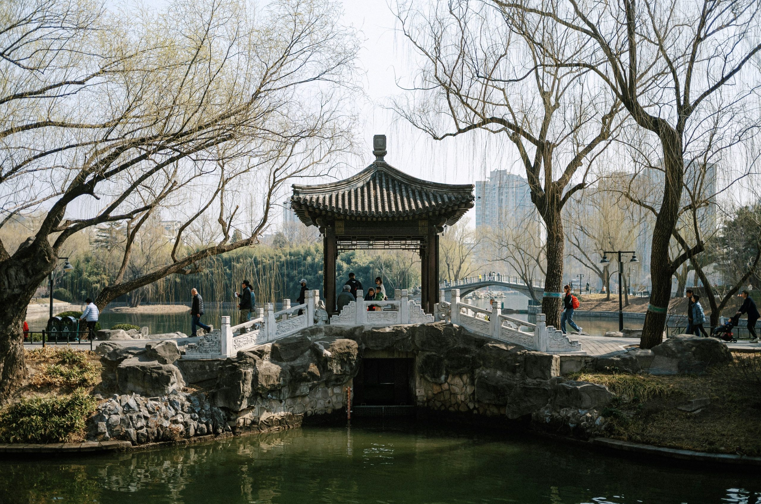 Traditional gazebo with arched bridge over water