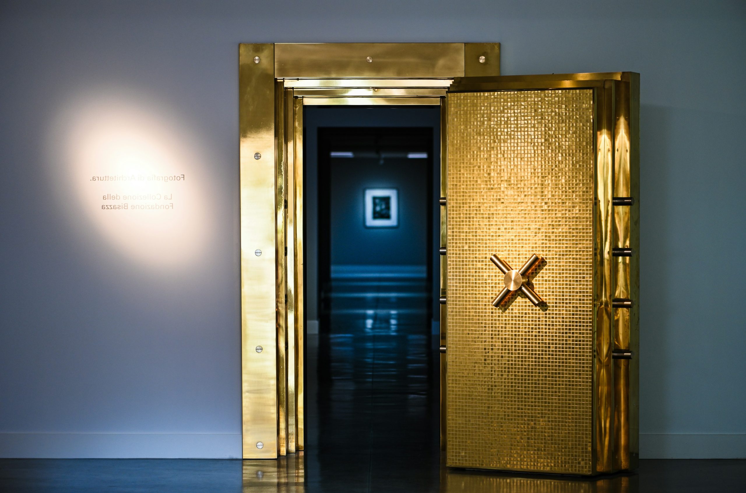 A gleaming golden vault door stands open.