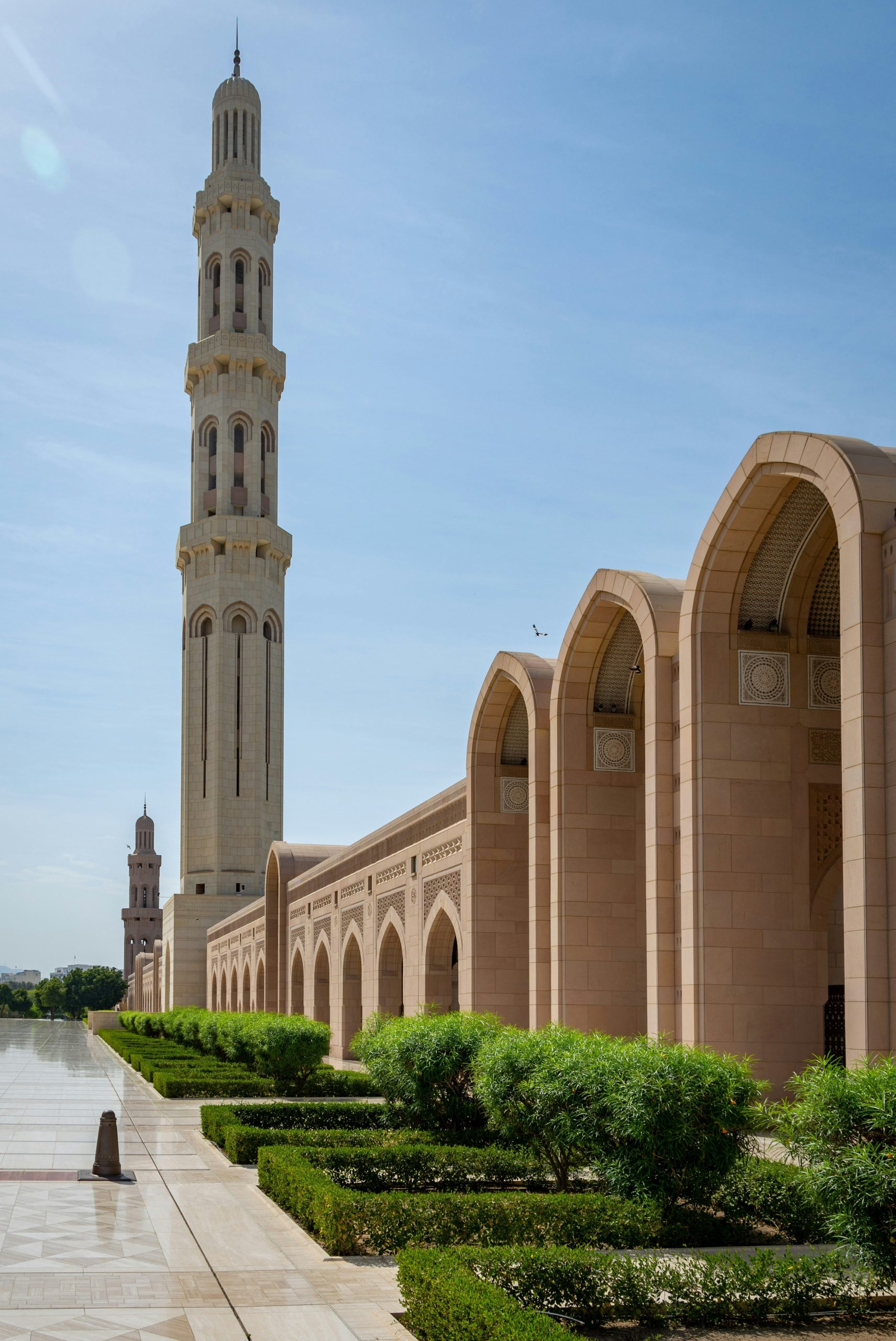 A grand mosque with tall minarets under a blue sky.
