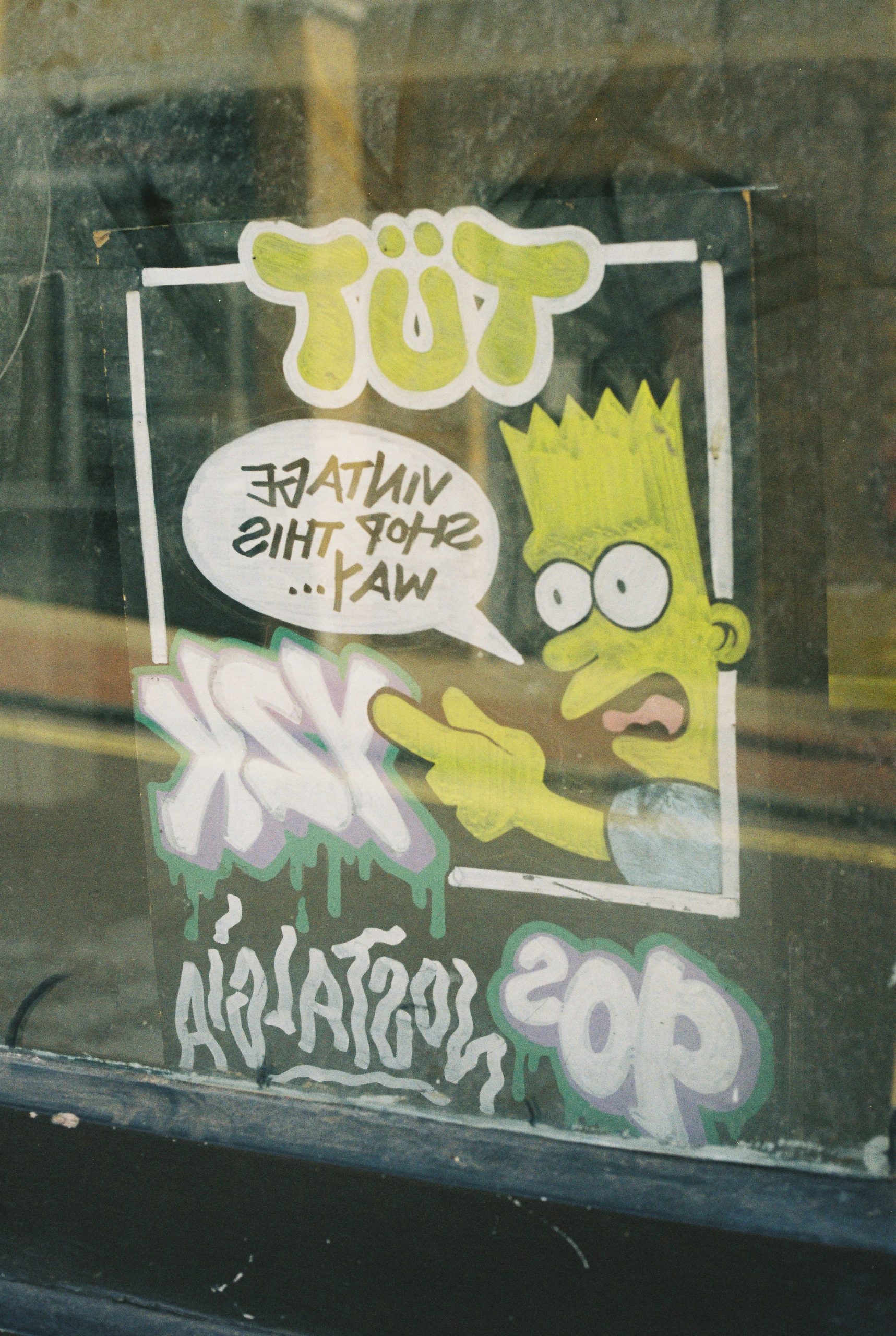 Bart simpson sticker advertises a vintage shop with 90s nostalgia.