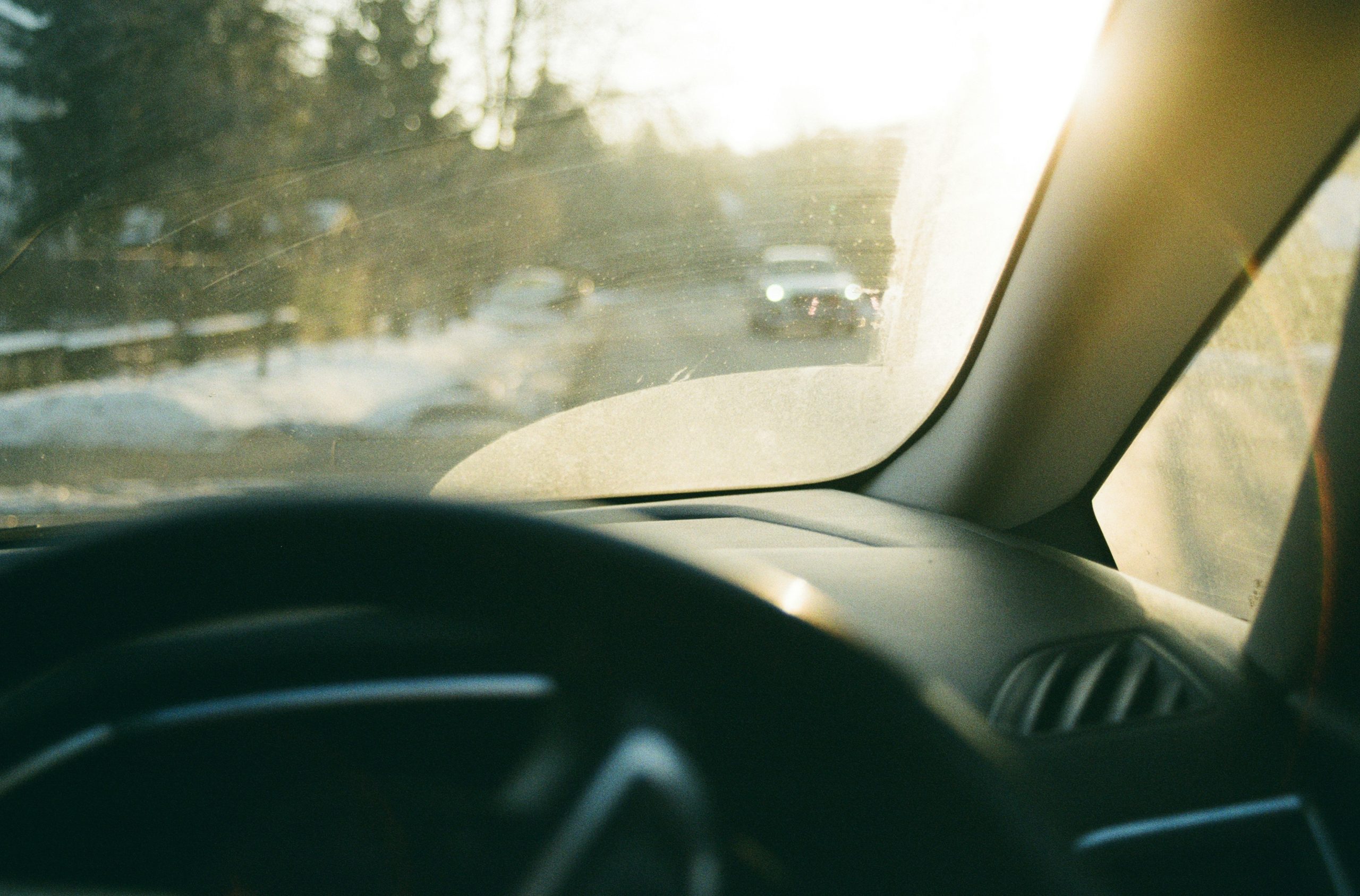 Driving on a snowy road with sun glare