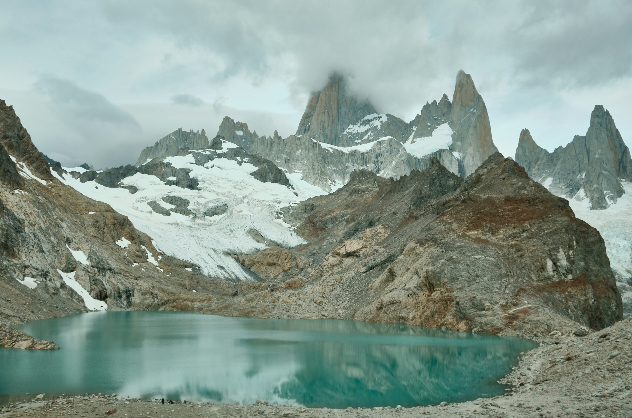 Jagged mountains rise above a turquoise lake.