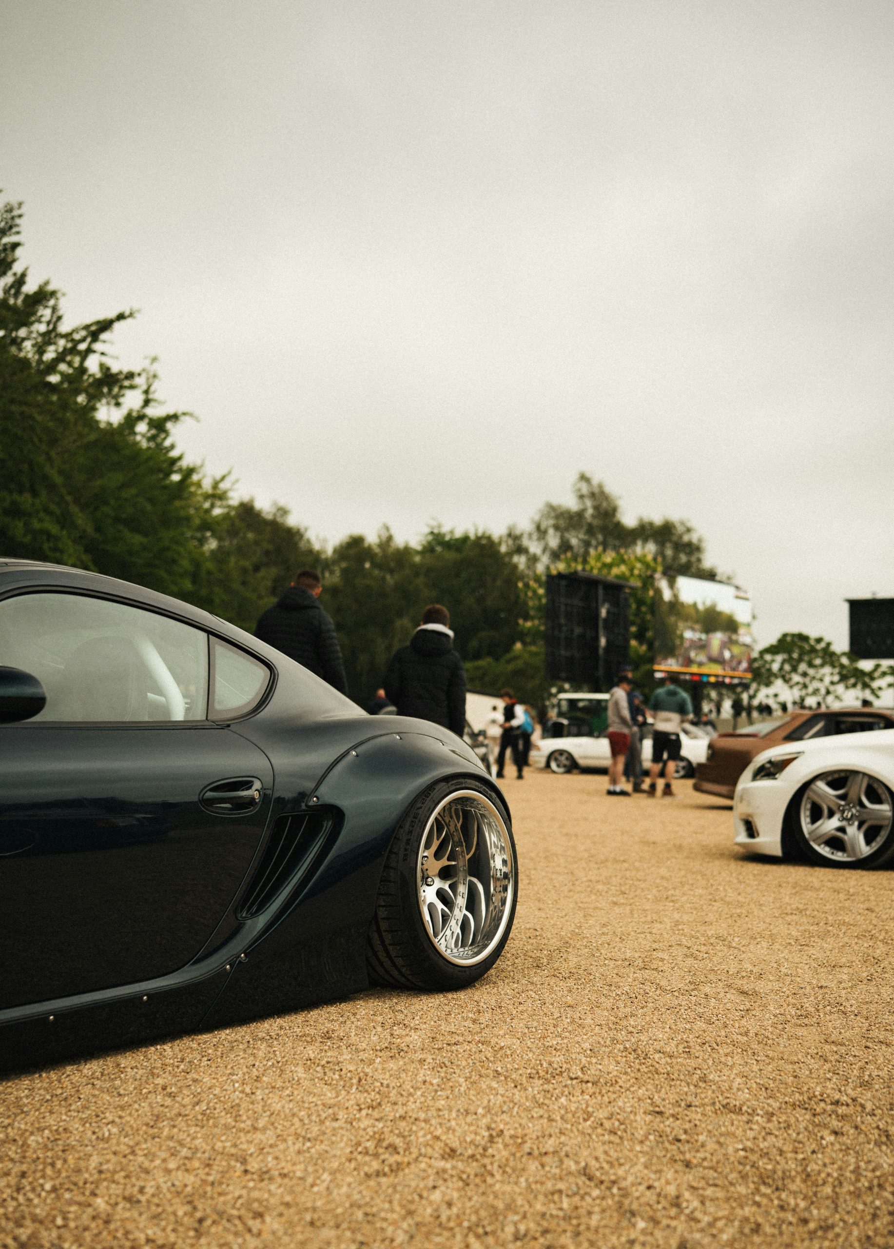 Modified sports cars parked at an outdoor event