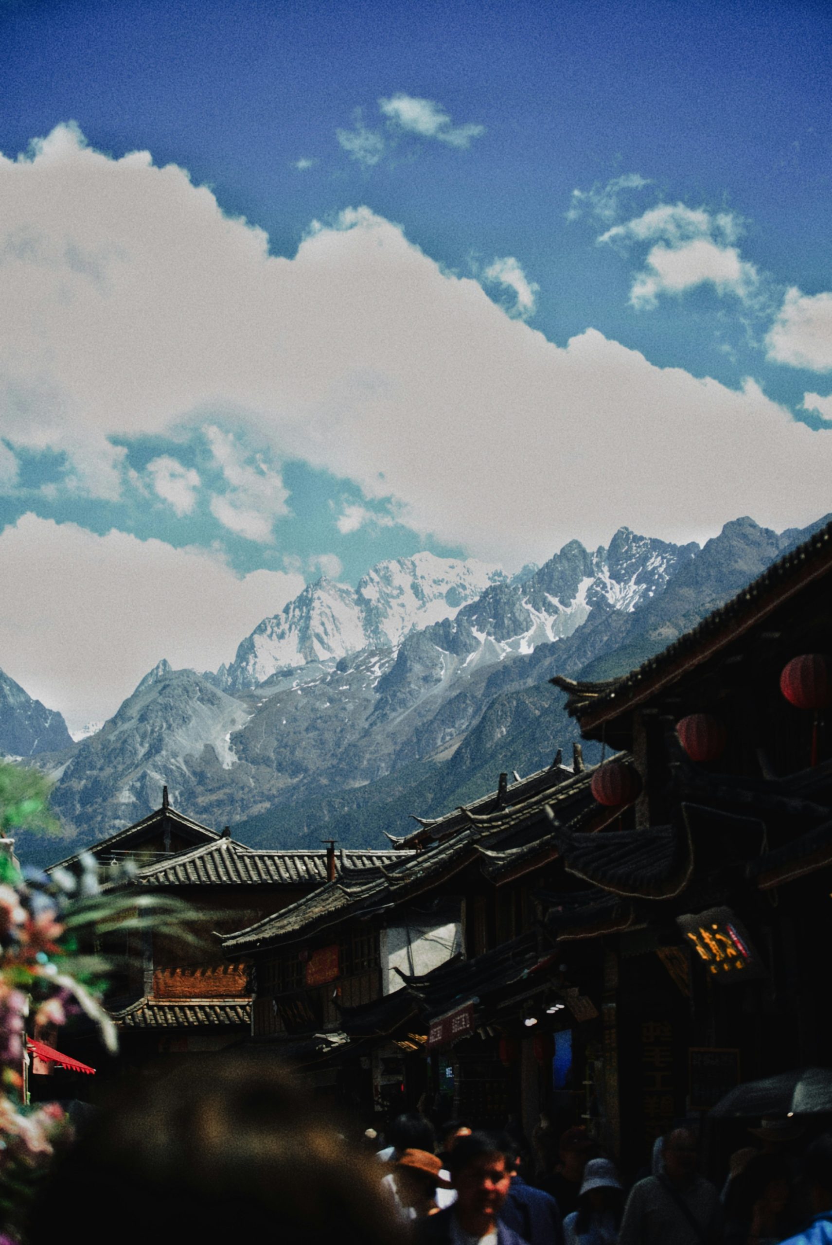 Rooftops in an old town with snowy mountains behind