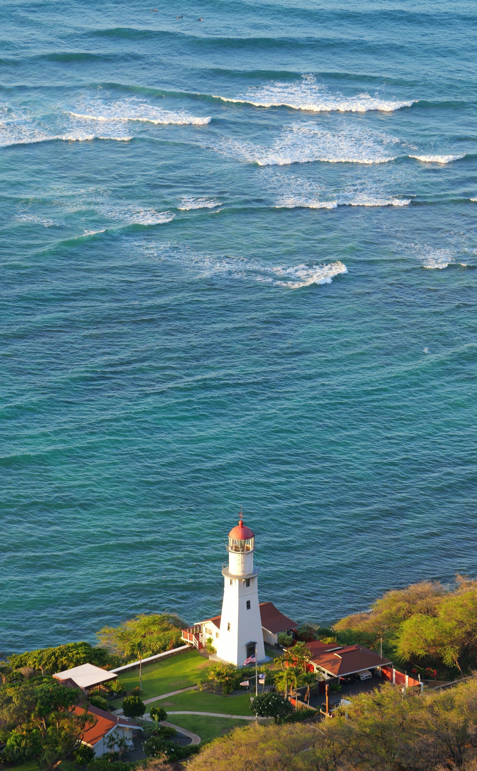 White lighthouse on a cliff overlooking the ocean