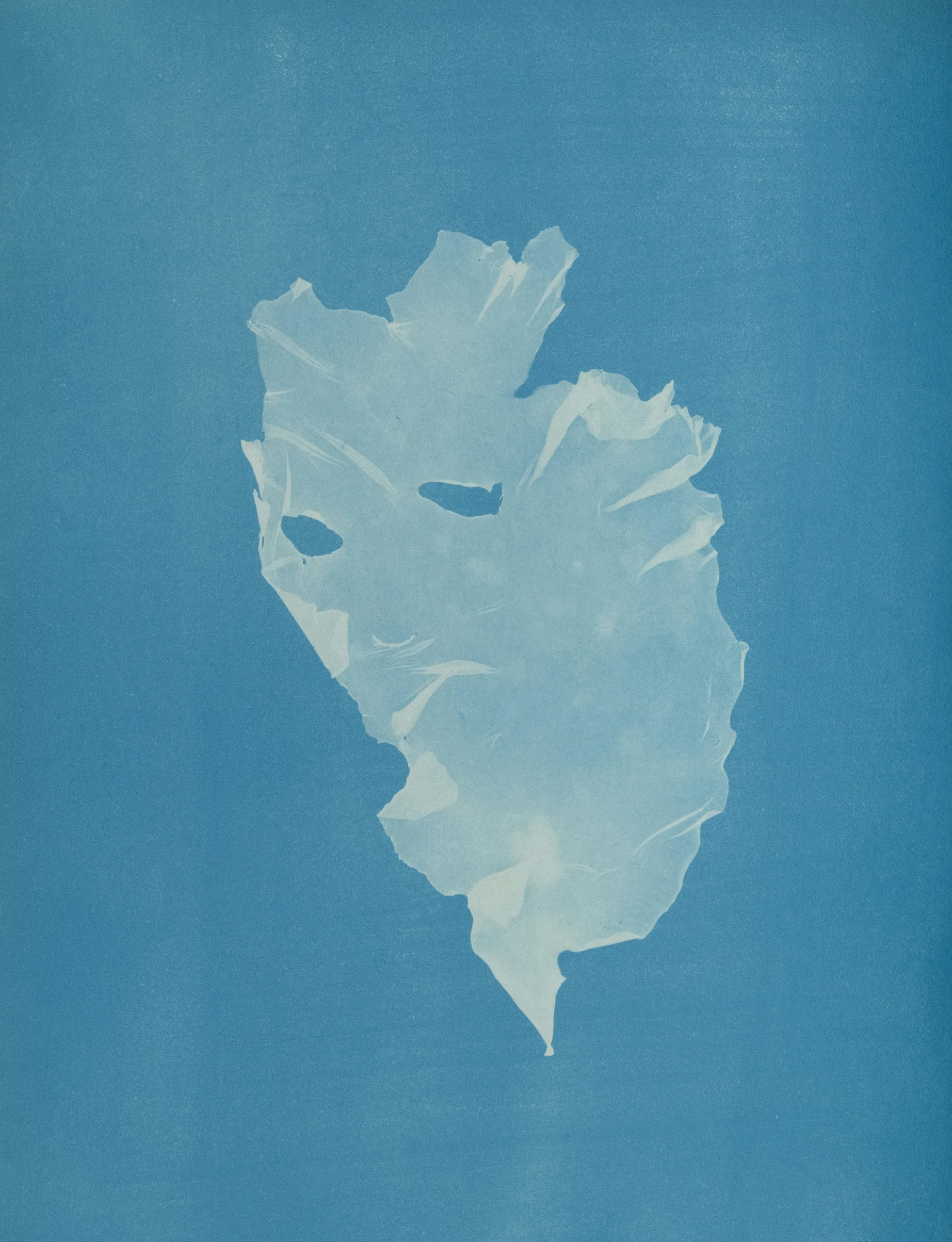 A crumpled light object against a solid blue background.