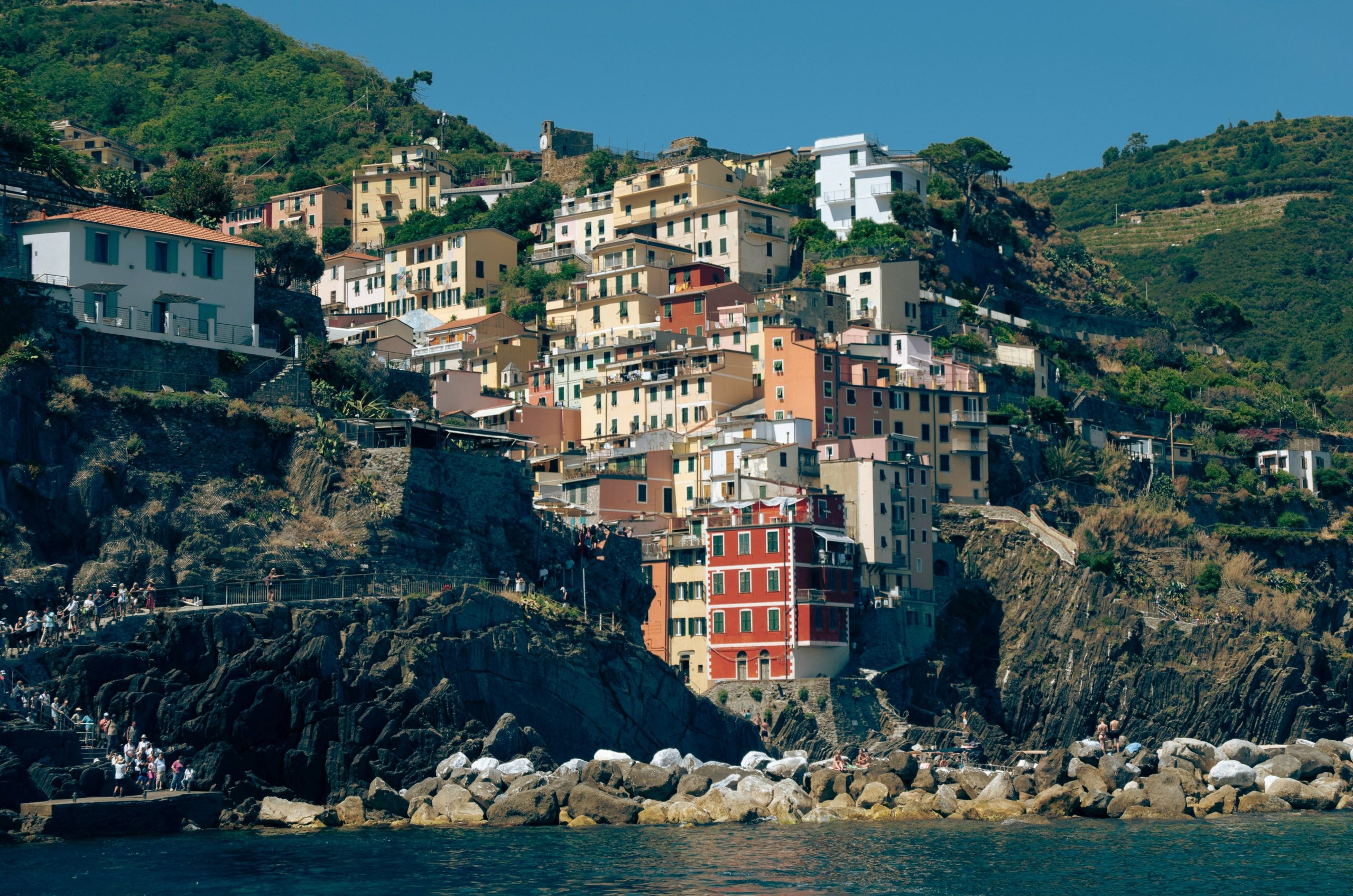 Colorful buildings on a steep hillside overlooking the sea.