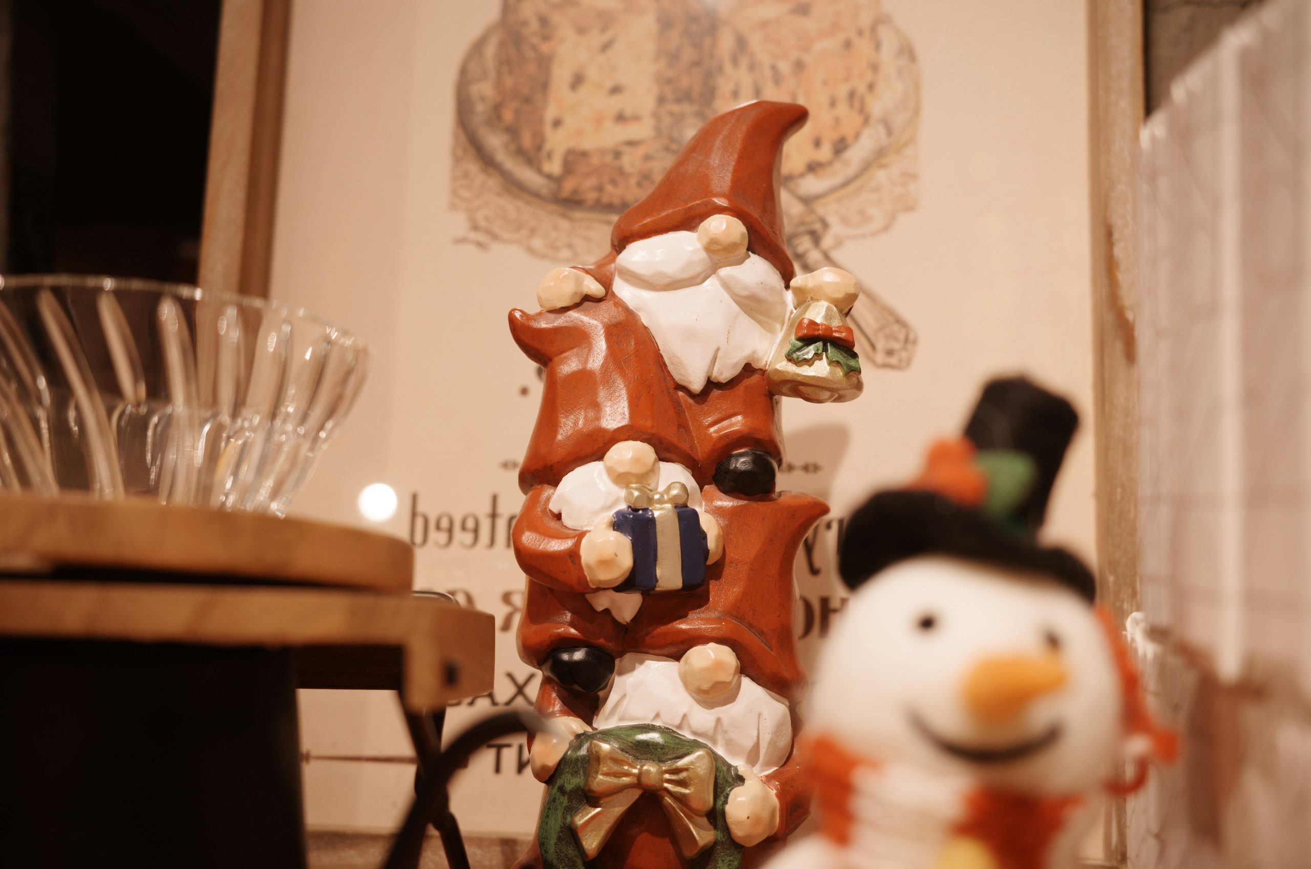 Festive stacked gnomes and a snowman decoration.
